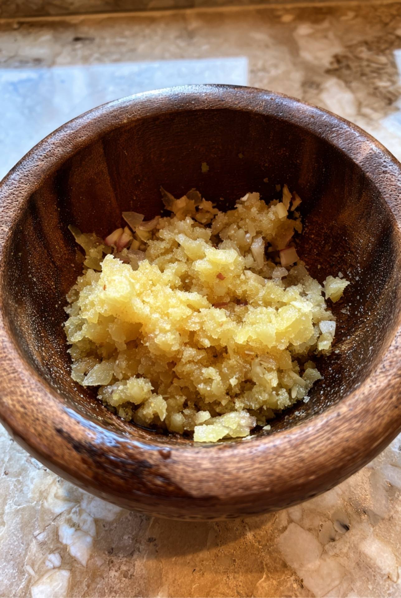 Garlic paste in a wooden bowl for ground lamb kebabs preparation