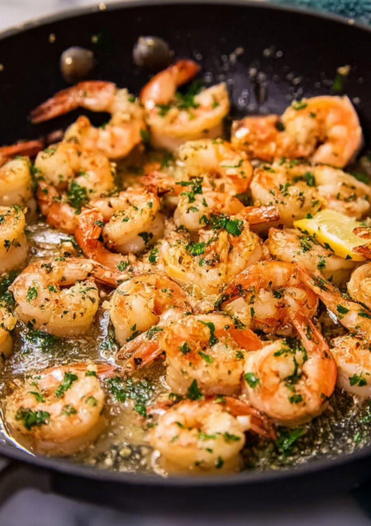 Shrimp scampi cooking in a skillet with garlic, parsley, and butter sauce, ready to serve for a fast weeknight meal.