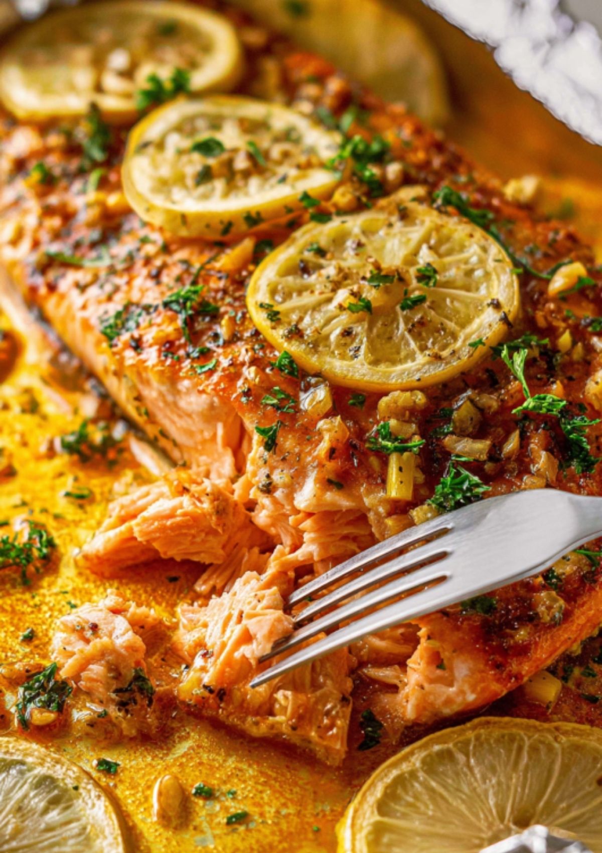 Juicy baked salmon garnished with parsley and lemon slices on a blue serving plate for an easy weeknight dinner.
