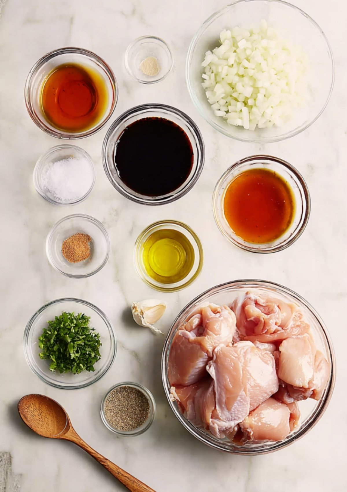 Chicken thighs searing in a black cast iron skillet with sizzling oil and golden edges.