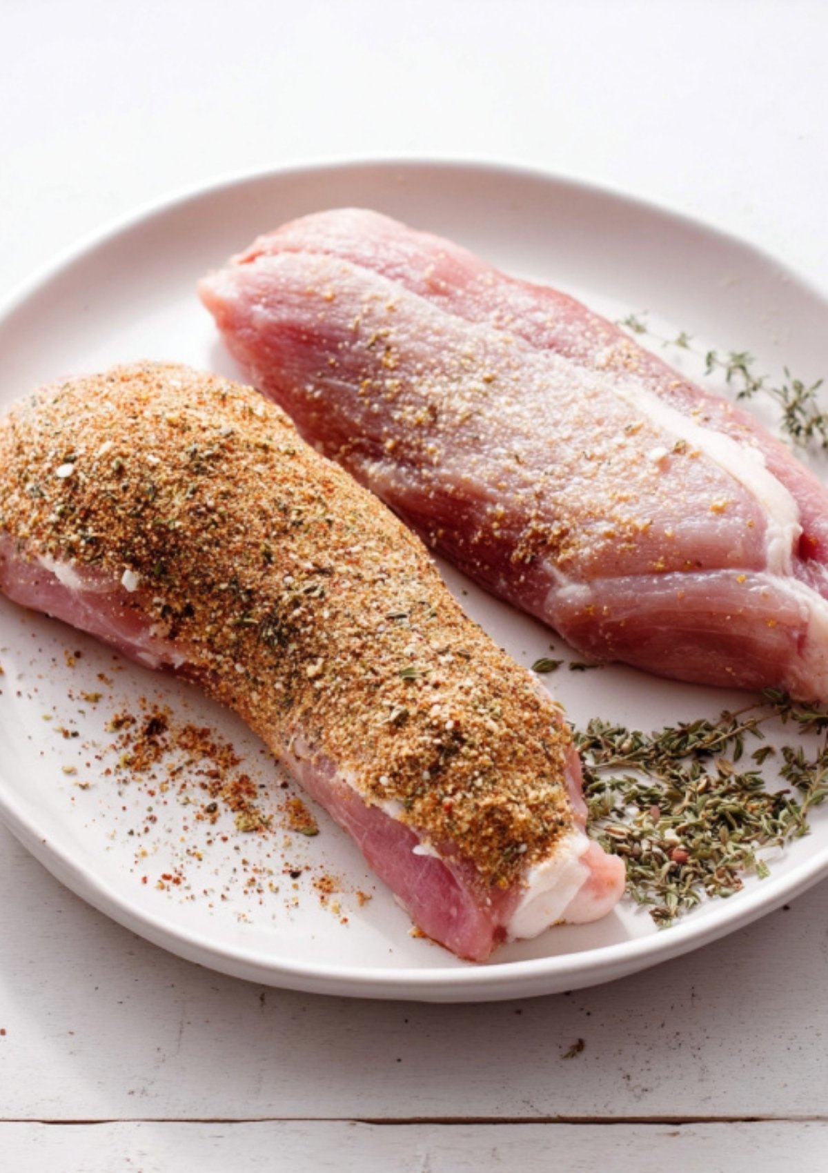 Perfectly seared pork tenderloins resting in the Instant Pot with herbs and pan juices for a rich base.