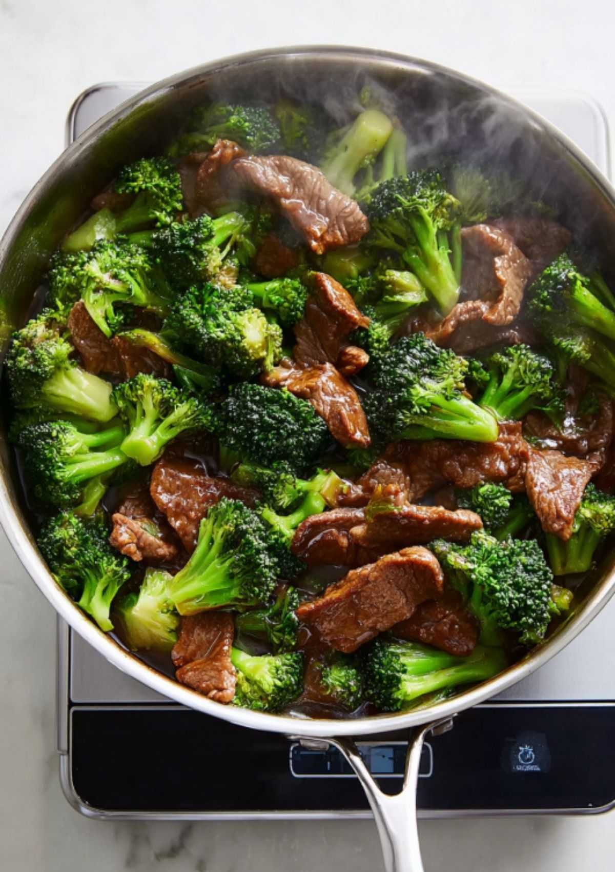 Close-up of juicy beef and vibrant broccoli coated in a glossy, savory garlic stir-fry sauce.