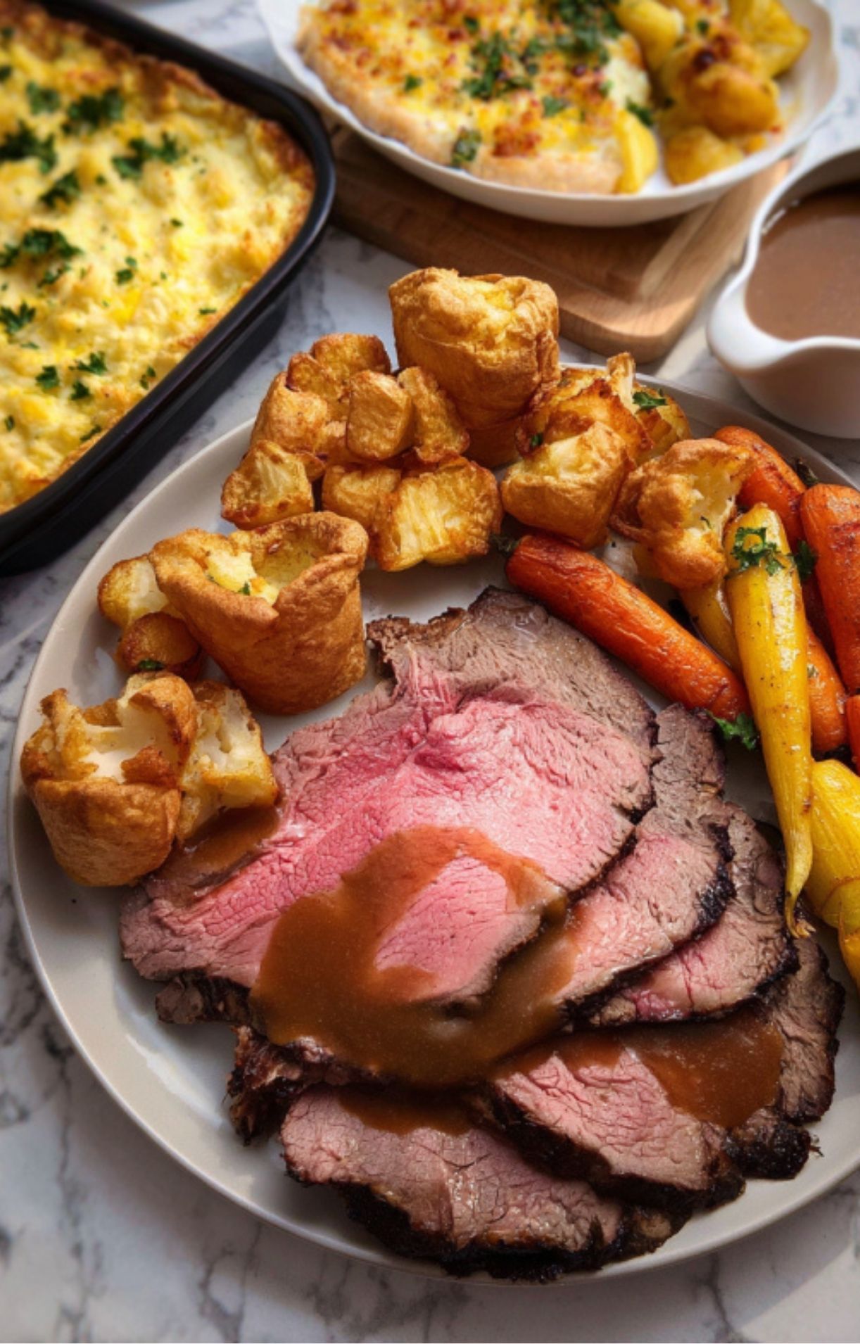 Traditional Sunday roast dinner with juicy sliced roast beef, golden Yorkshire puddings, crispy potatoes, roasted carrots, and rich brown gravy.