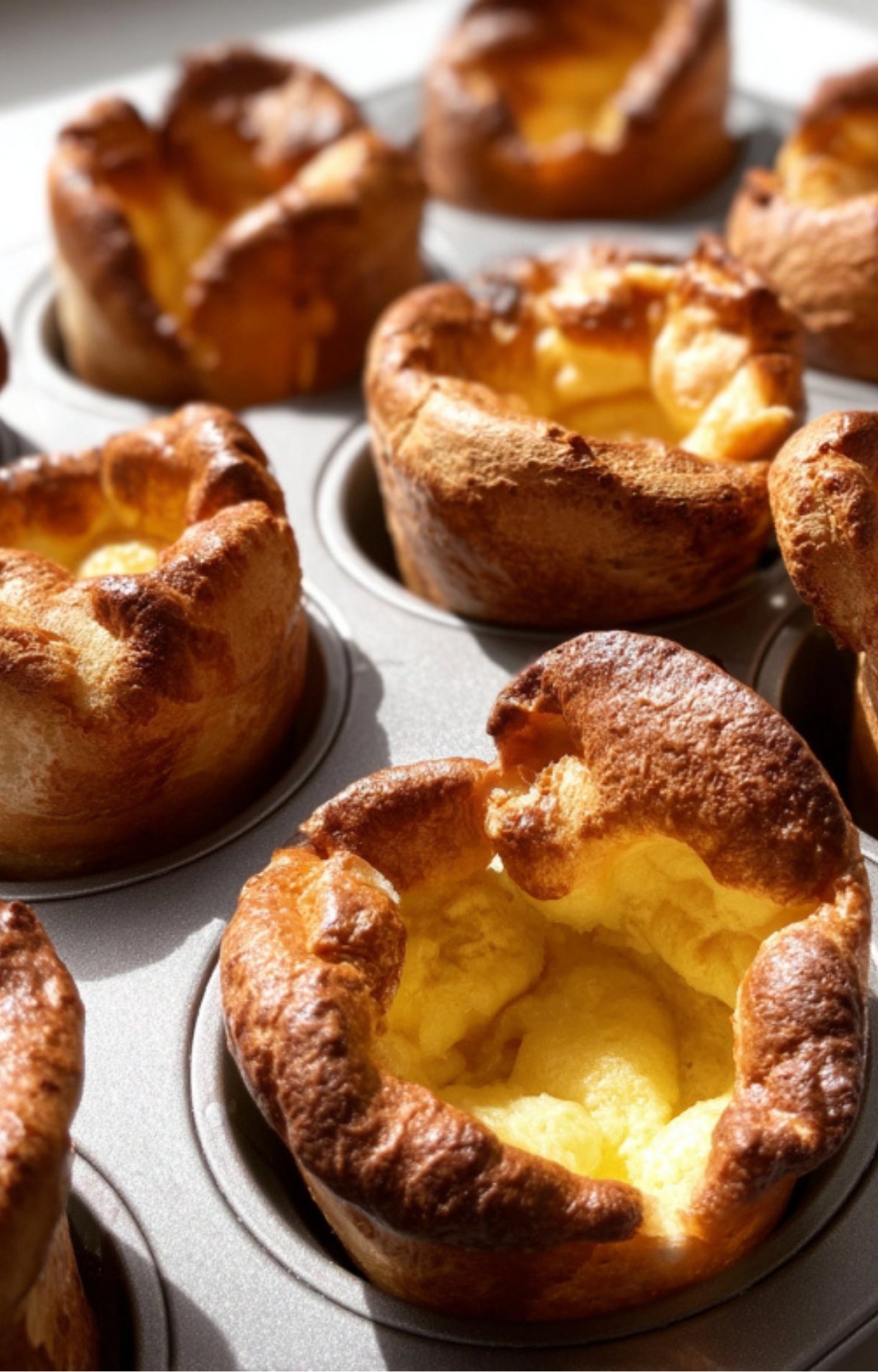 Golden, airy Yorkshire puddings baked to perfection in a muffin tin, a beloved British side for Sunday roast dinners.