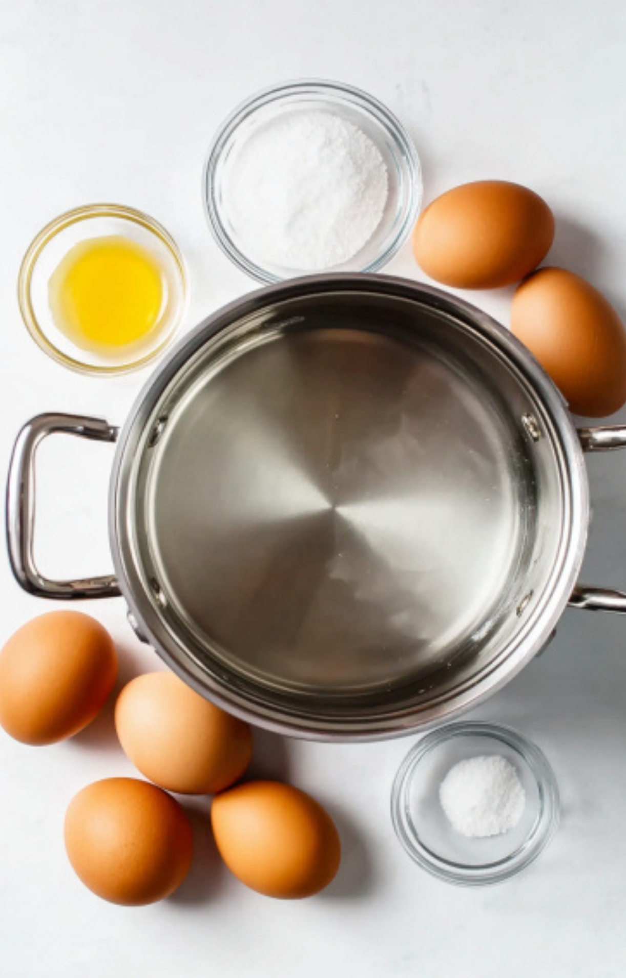 Eggs, salt, vinegar, and a pot arranged for boiling eggs