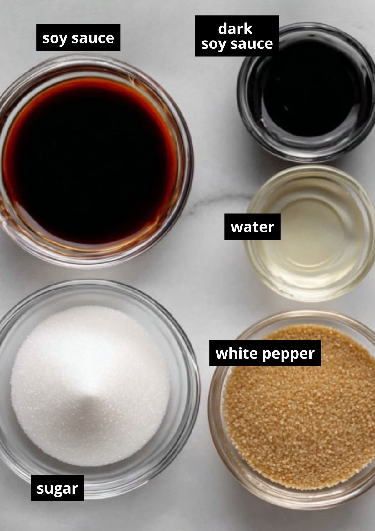 Bowls of soy sauce, dark soy sauce, water, sugar, and white pepper labeled as ingredients for the perfect noodle sauce.