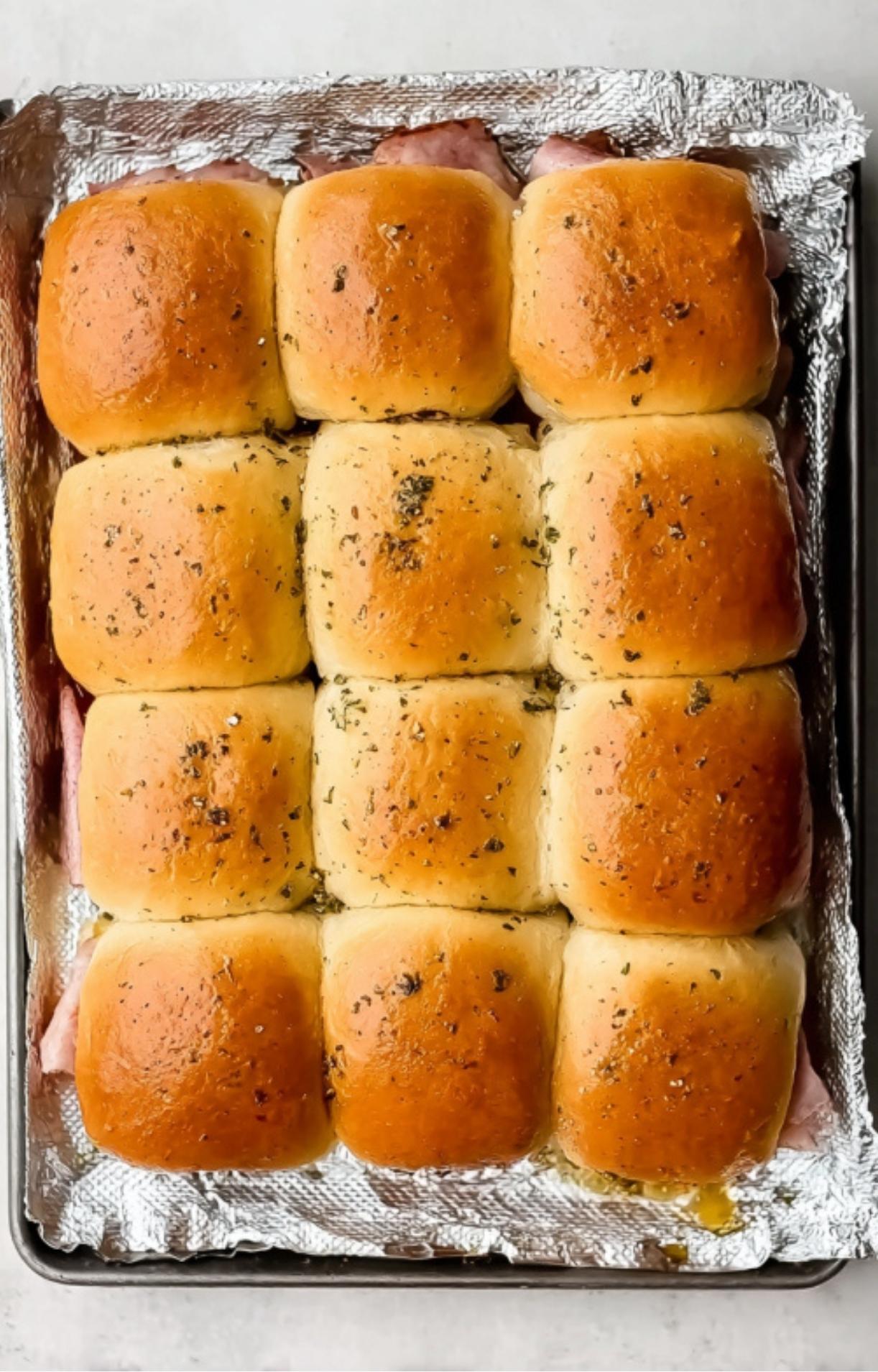 Golden brown roast beef sliders fresh from the oven, brushed with garlic butter and baked until soft and cheesy.