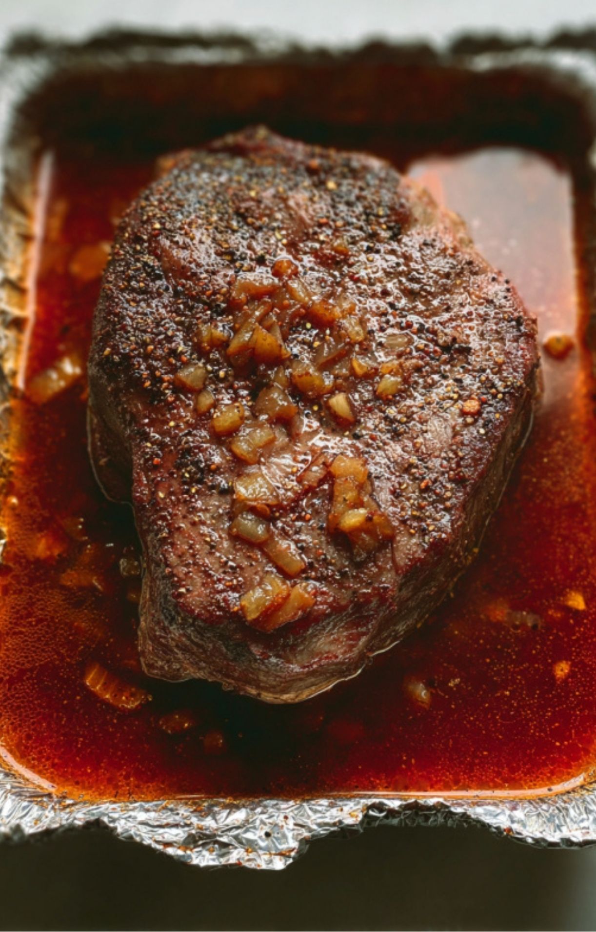 Juicy pulled smoked beef chuck roast in a bowl, topped with parsley, great for comfort food meals
