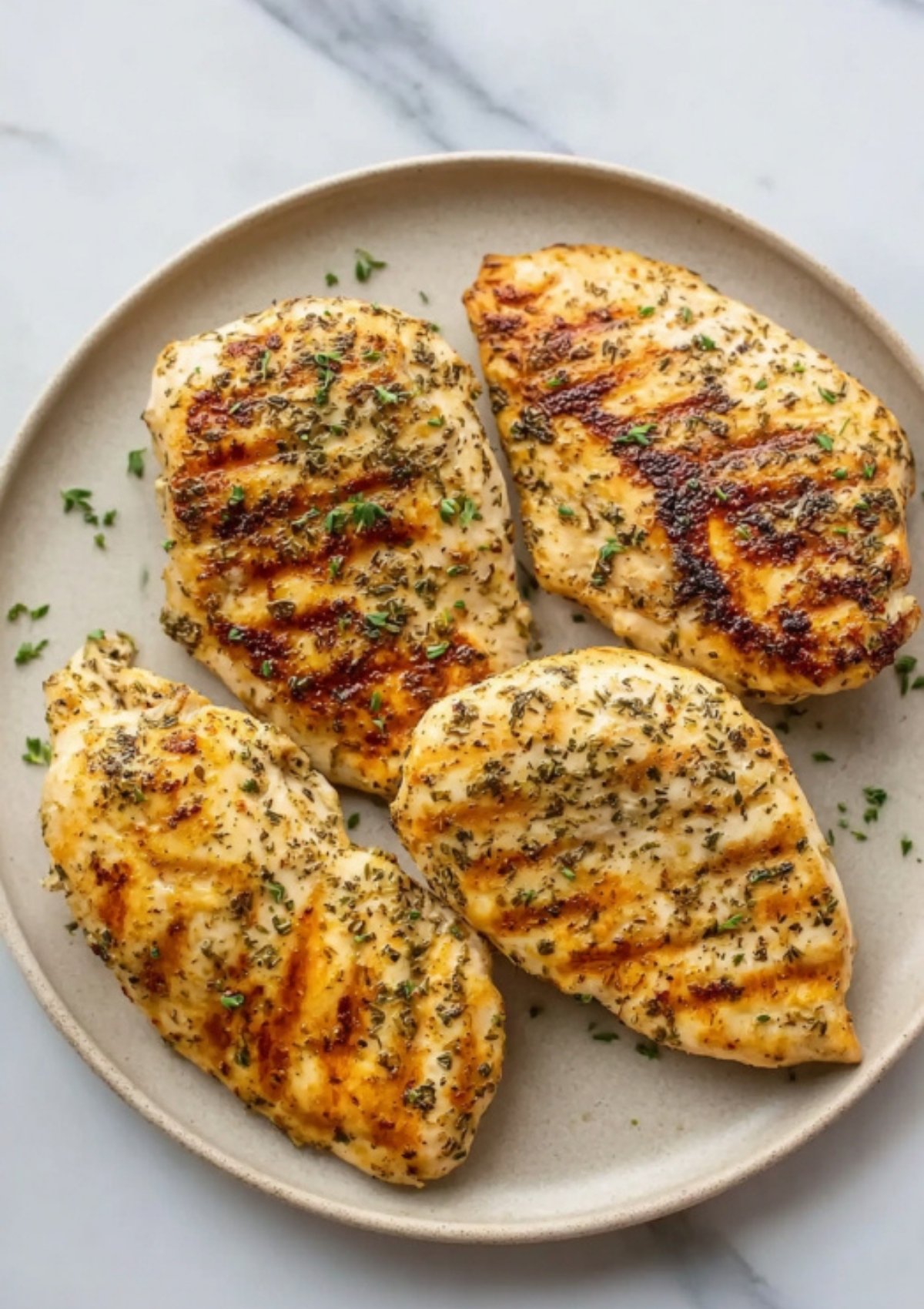 Grilled chicken breasts seasoned with herbs, perfect for easy bacon ranch chicken bake recipes and healthy weeknight dinners.