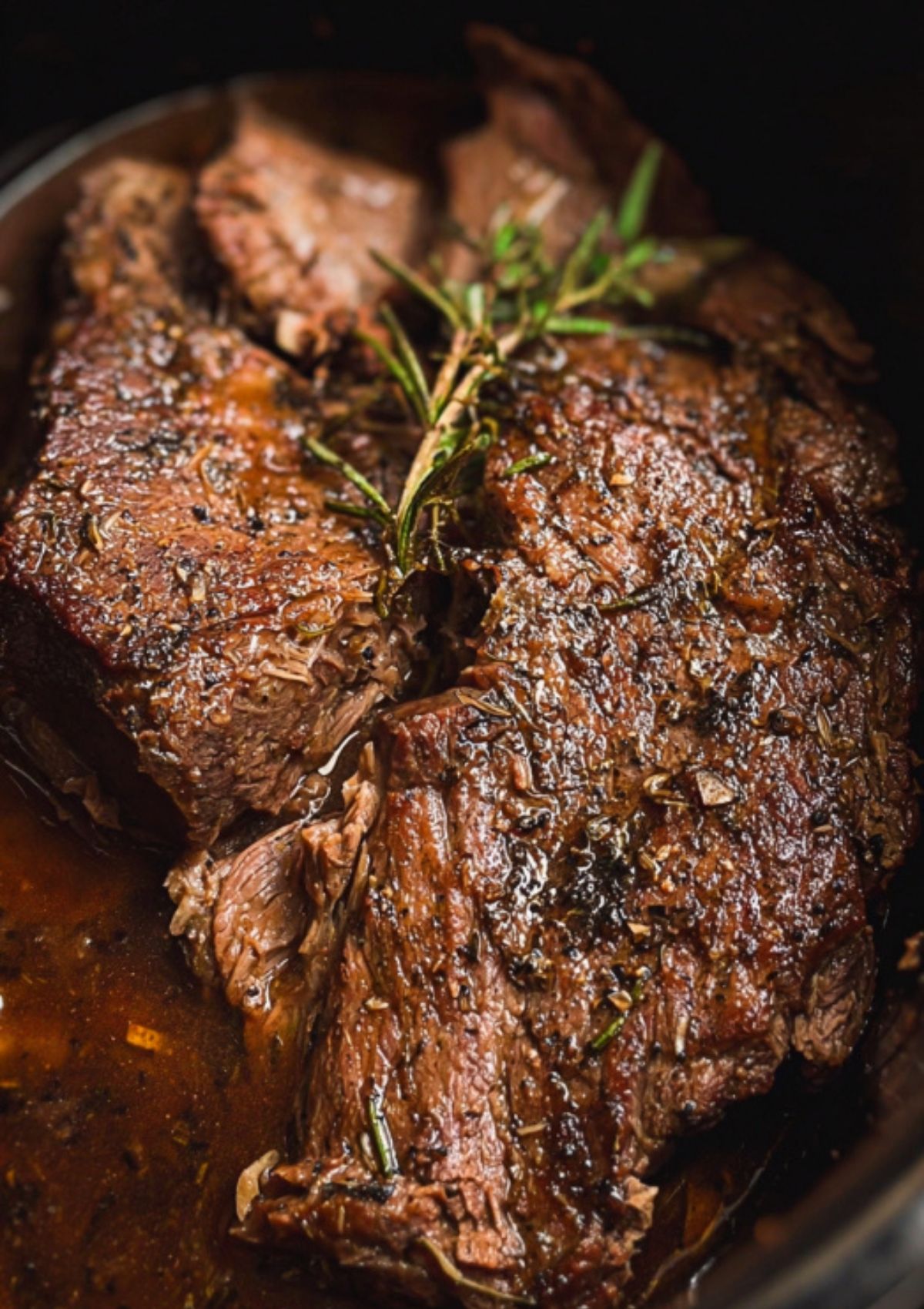 Chuck roast cooked in a crock pot with herbs and juices, fork-tender and packed with flavor
