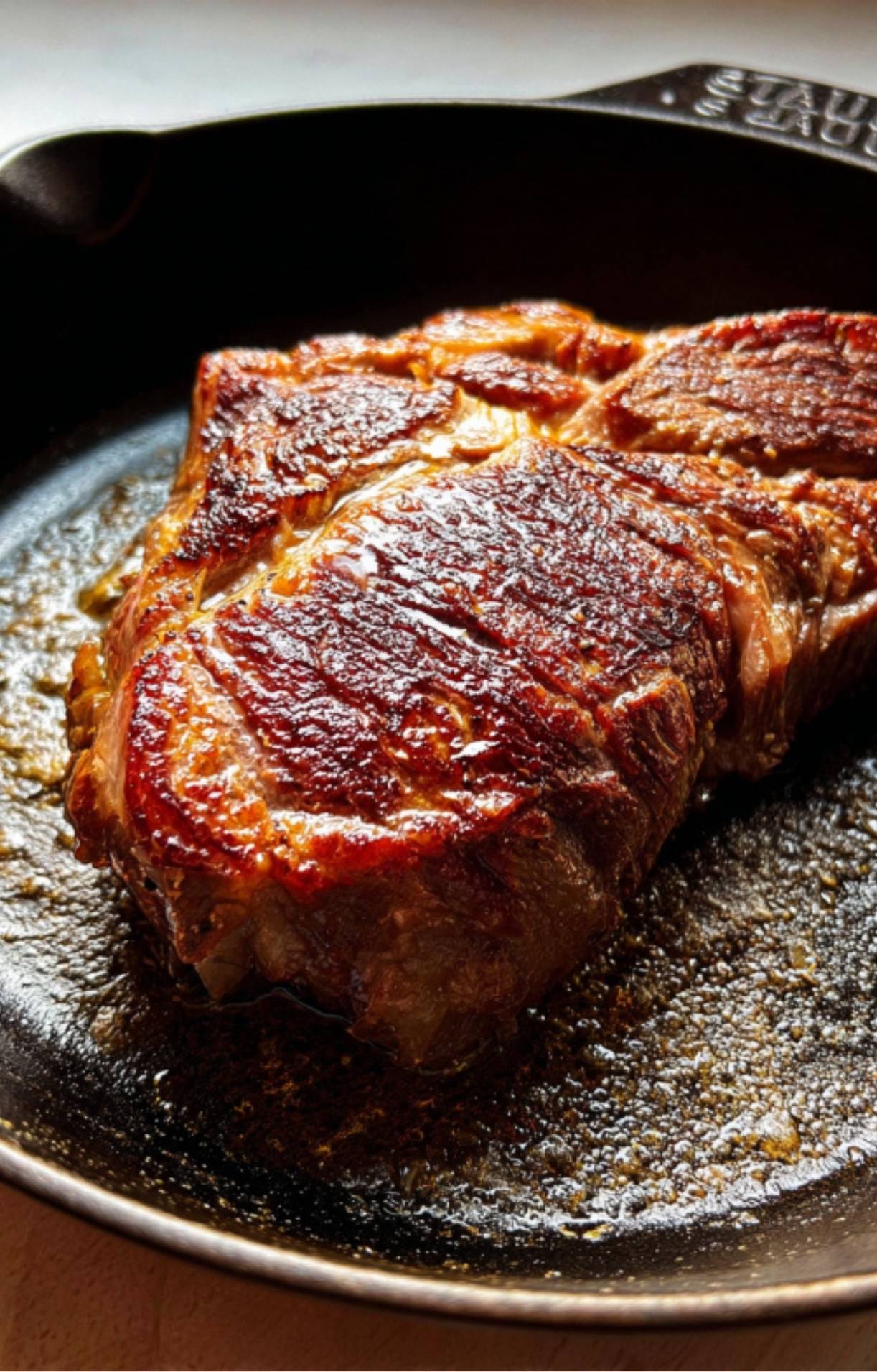 Beef roast searing in a skillet to lock in flavor for a juicy crockpot roast, ideal for cozy comfort food nights.