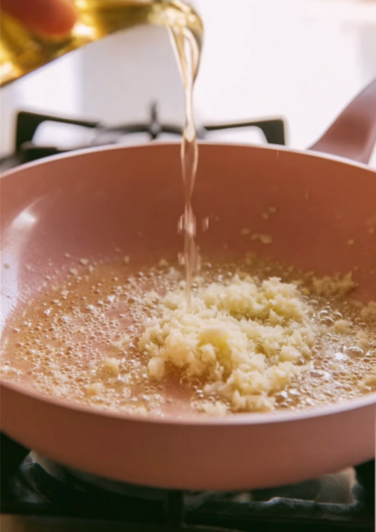 Fresh minced garlic sizzling in butter to make garlic butter shrimp pasta