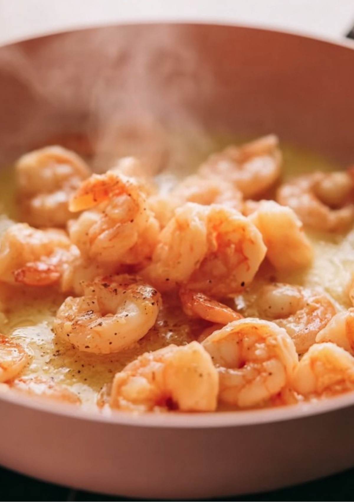 Shrimp sautéing in garlic butter for rich pasta sauce