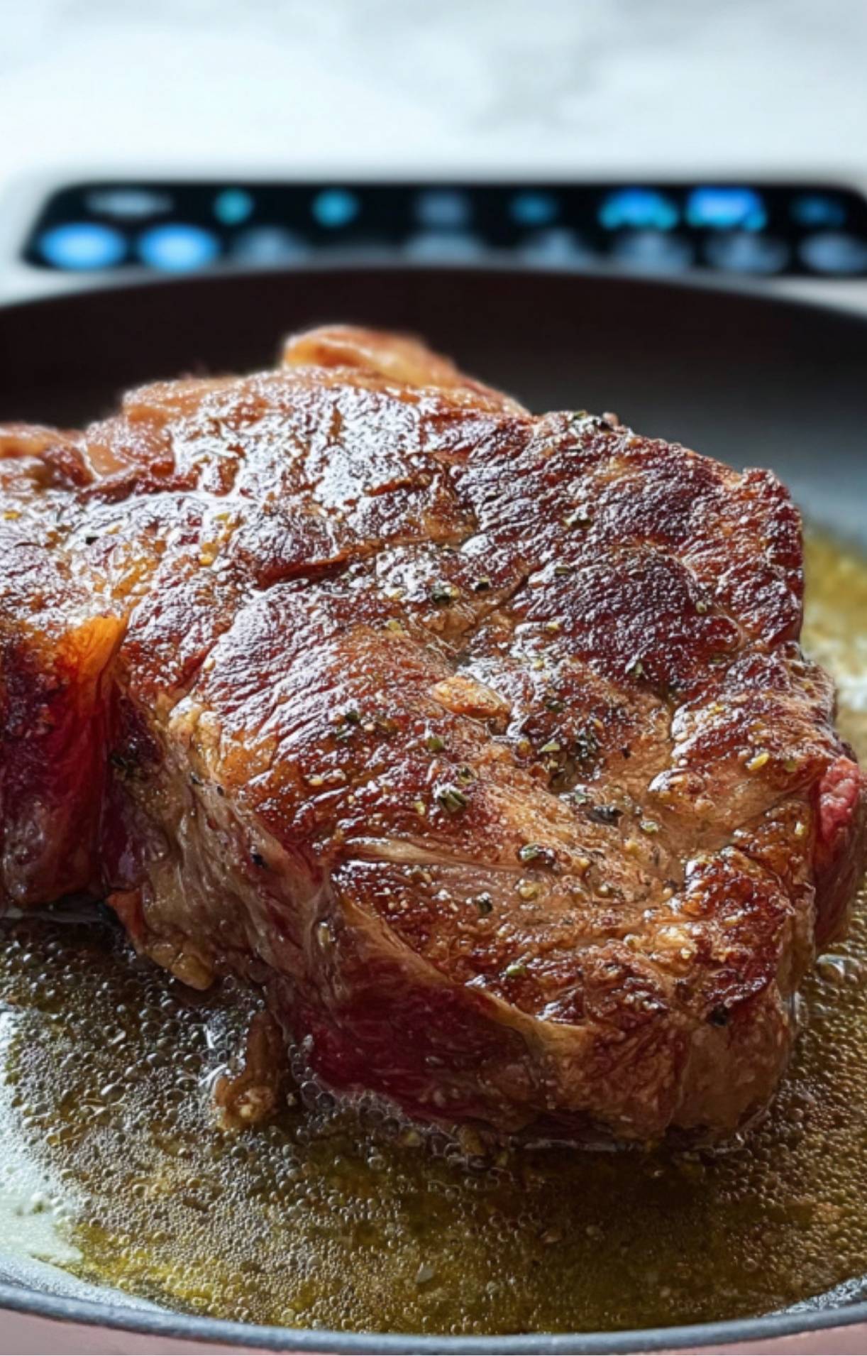 Chuck roast searing in a pan, building flavor for a classic slow cooker pot roast.