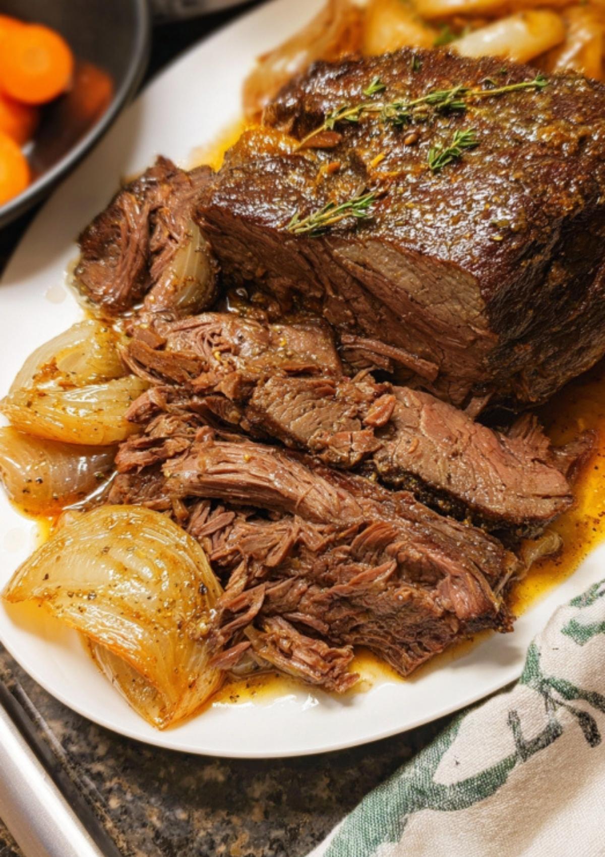 Sliced roast beef crock pot served on a plate with tender onions and rich juices. Perfect comfort food for family dinners and meal prep.