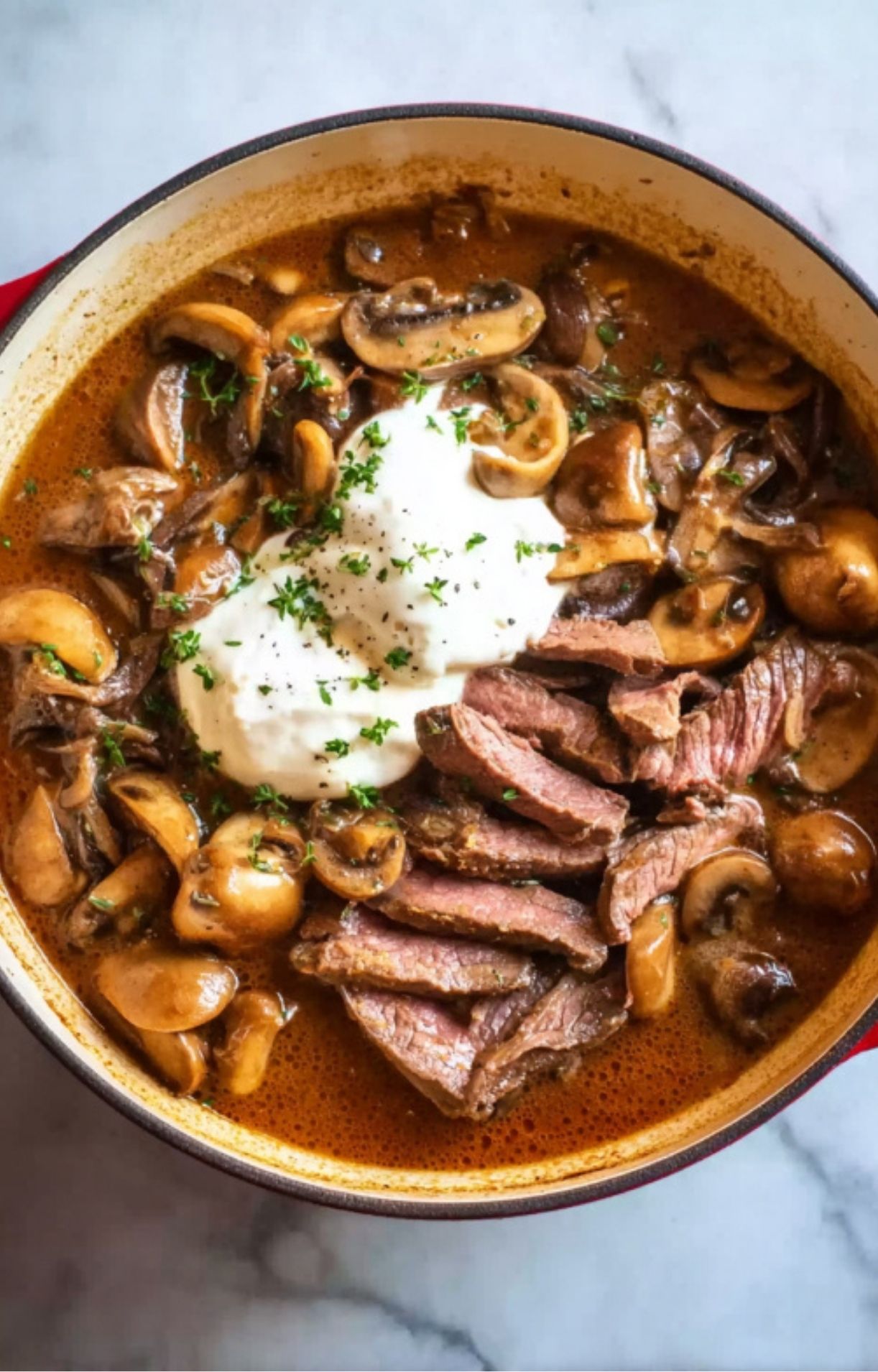 Tender strips of leftover roast beef in a creamy stroganoff sauce with sautéed mushrooms, onions, and a dollop of sour cream, finished with fresh parsley.