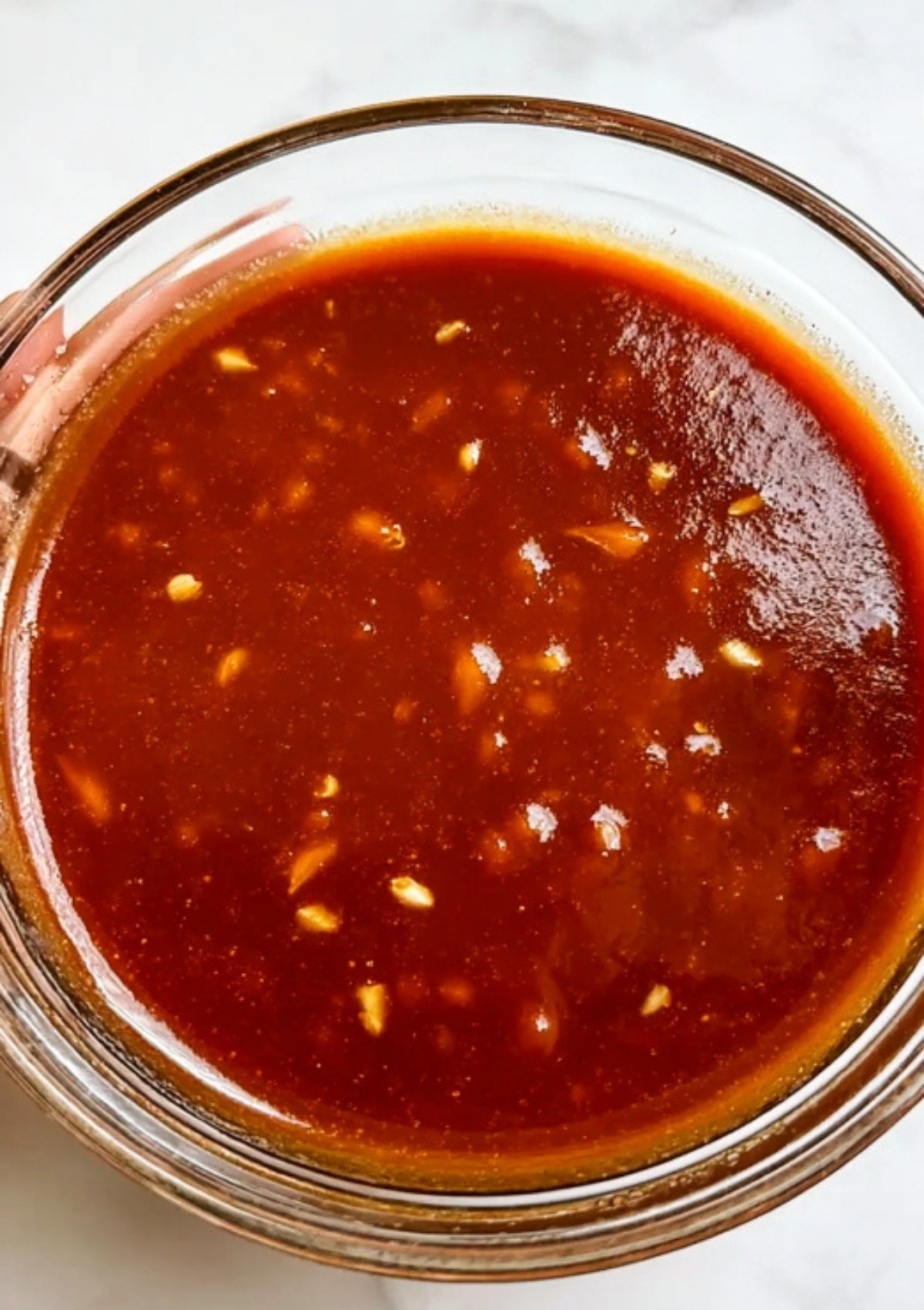 Glass bowl filled with homemade barbecue sauce, ready for pulled pork or sandwiches.