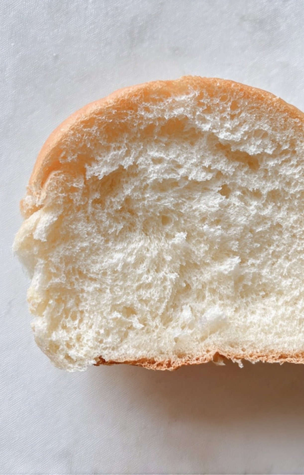 A slice of soft white sandwich bread, perfect for building a deli-style sandwich