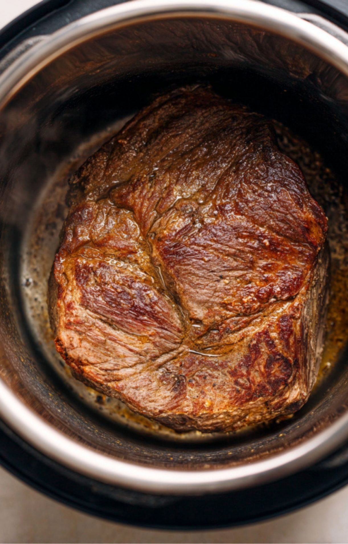 Beef chuck roast browning in an Instant Pot for extra flavor