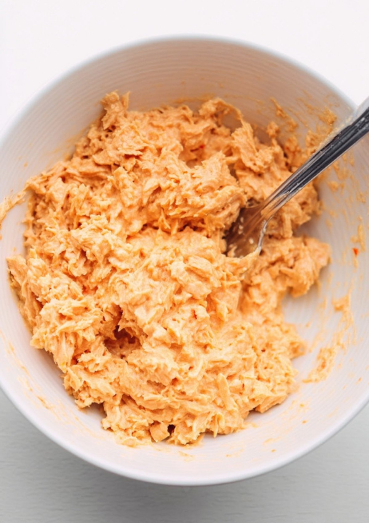 Bowl of spicy tuna mixture made with creamy mayo and sriracha—perfect protein topping for spicy tuna rice bowls.