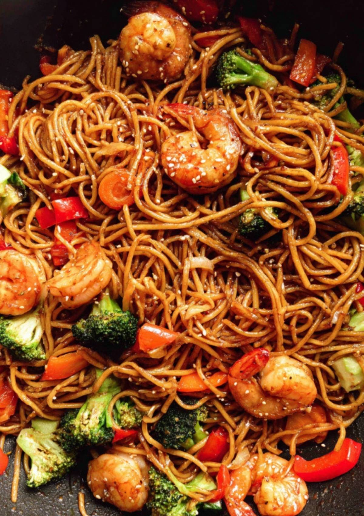 Noodle stir fry with shrimp, broccoli, and peppers tossed in sesame sauce.