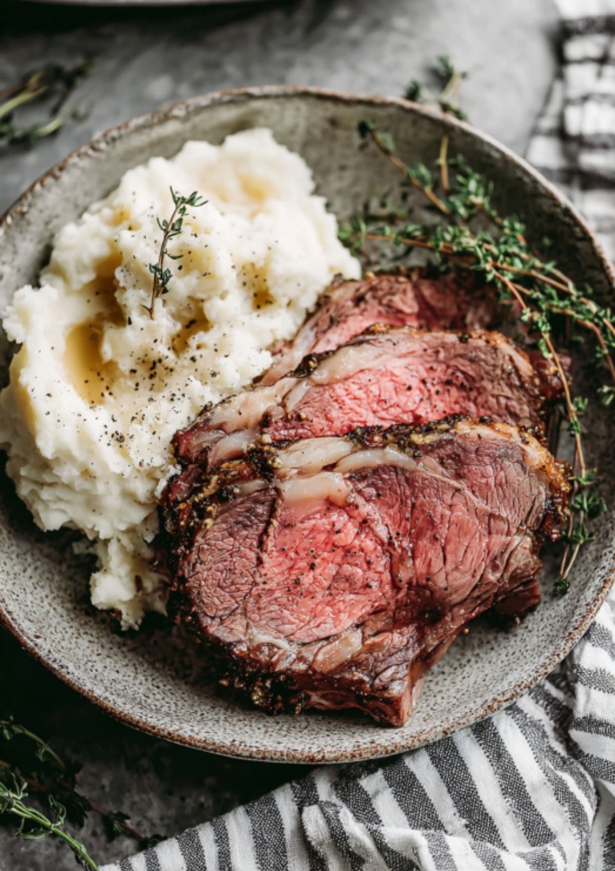Prime rib roast on a wooden board with a crisp herb crust, juicy slices ready for serving