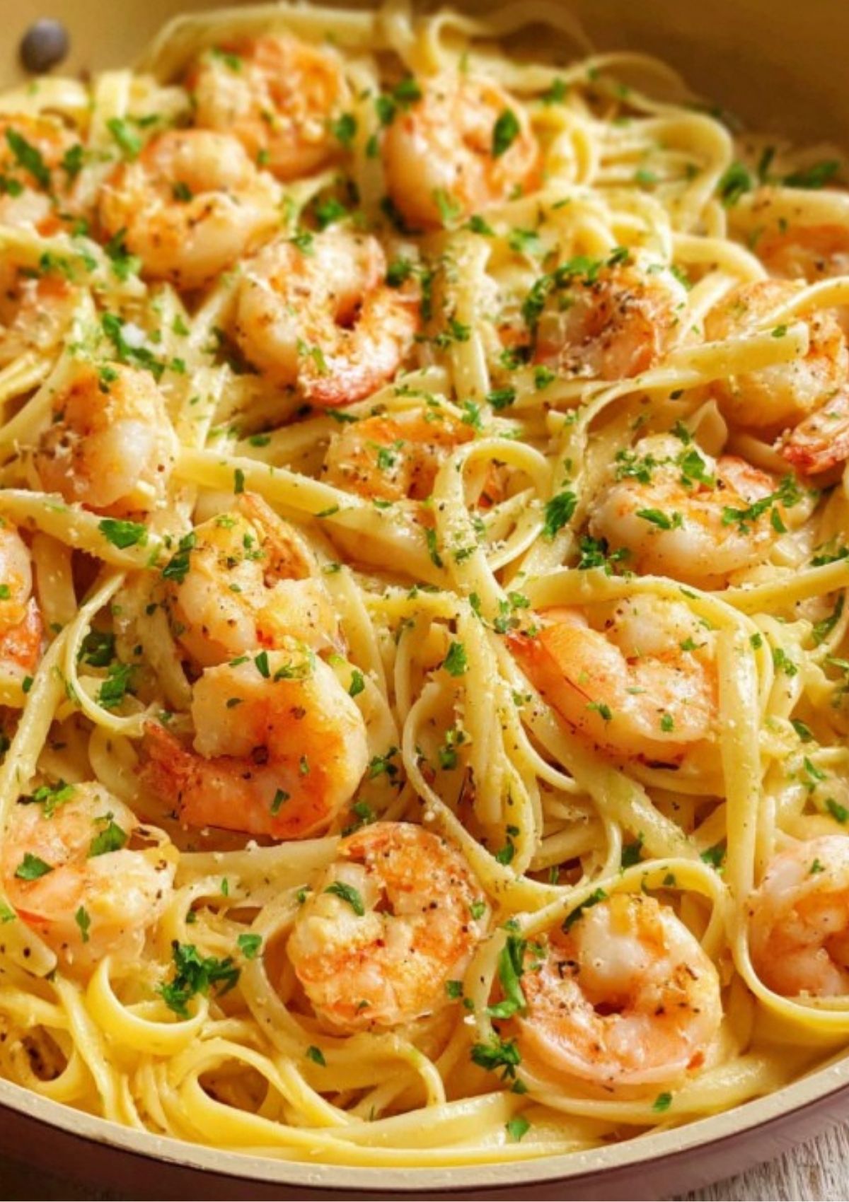 Creamy garlic butter shrimp pasta topped with parsley and Parmesan