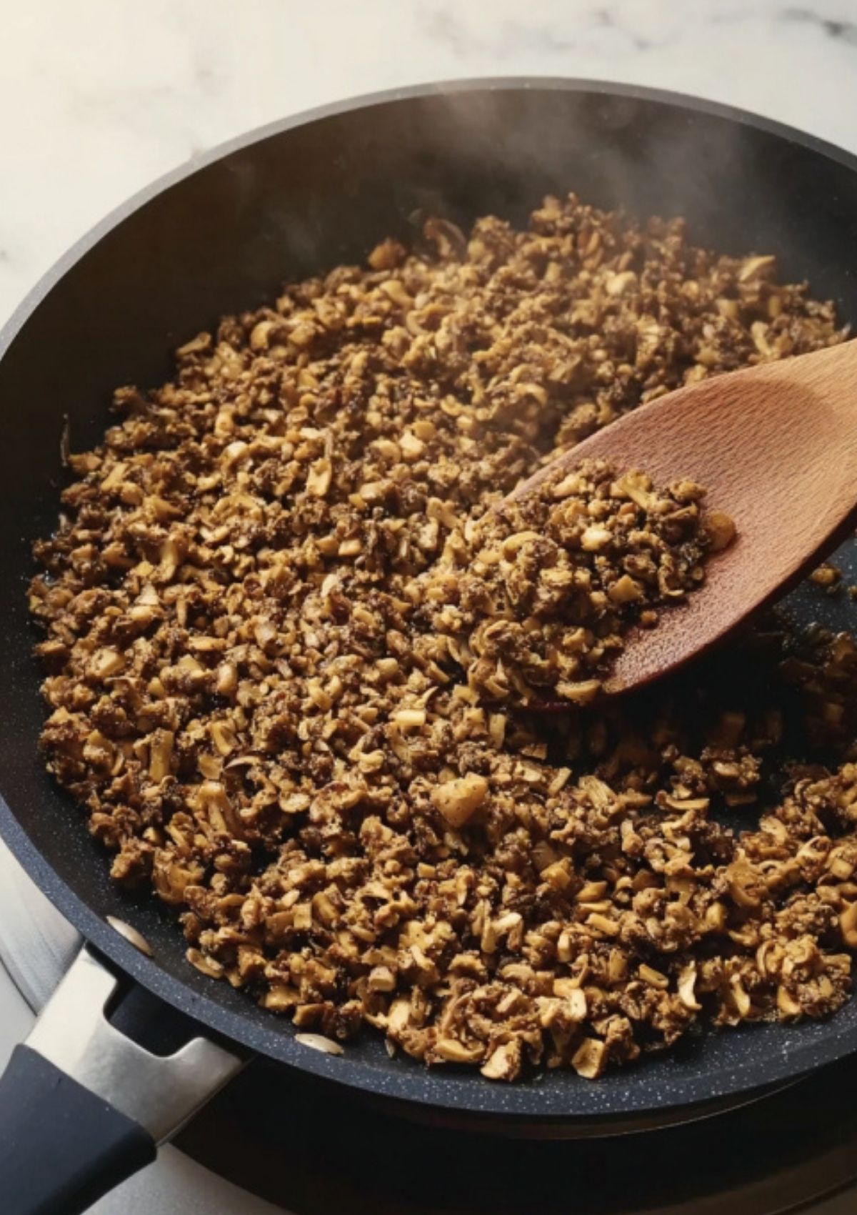 Tender beef fillet wrapped in thin prosciutto and plastic wrap, prepped for the next step in this holiday air fryer beef wellington.
