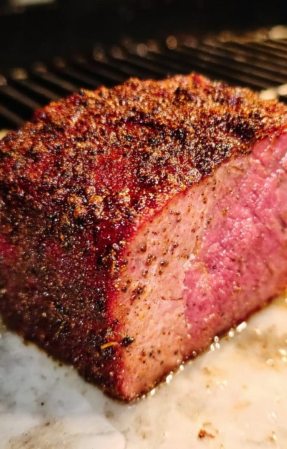 Smoked beef tenderloin with seasoned crust resting before wrapping