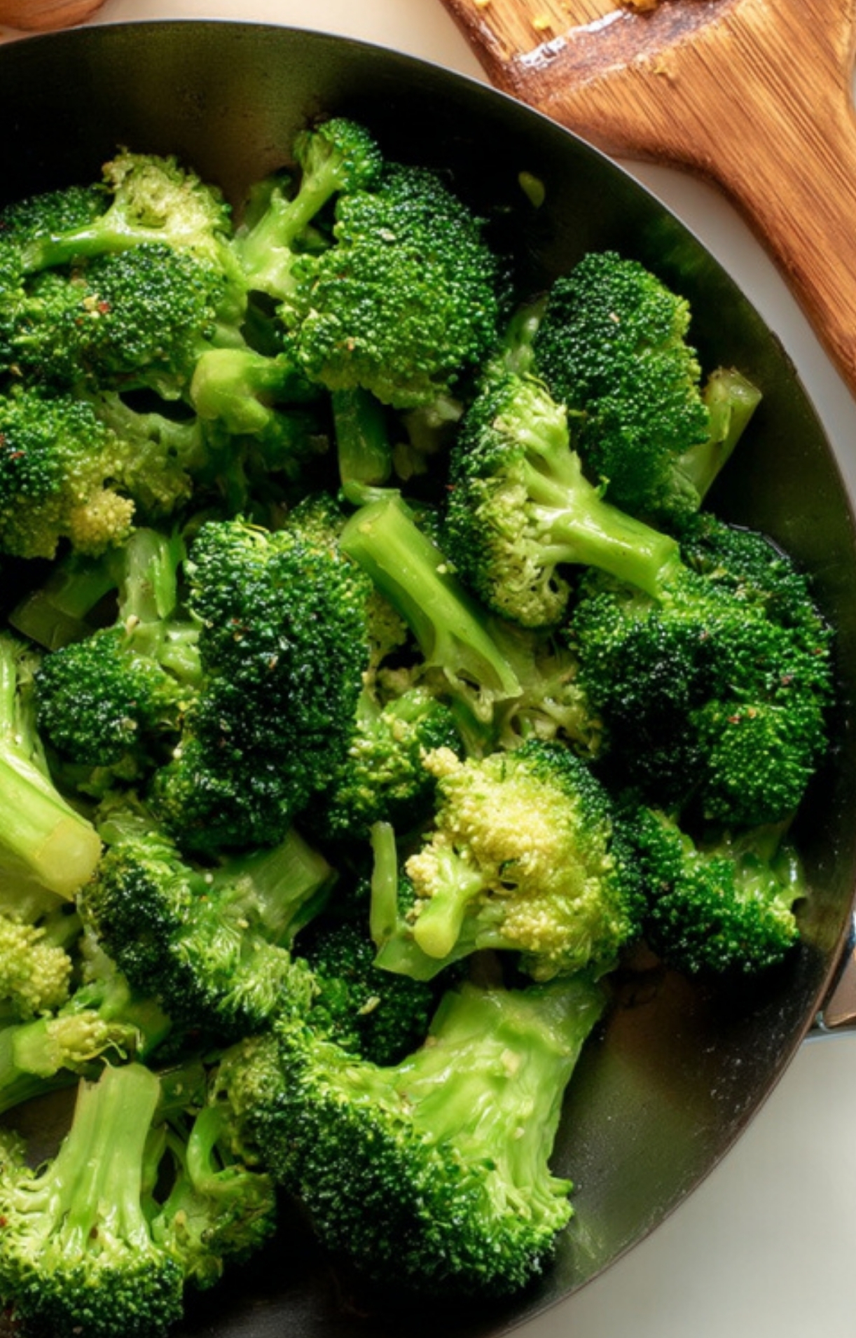 Bright green broccoli florets sautéed in a skillet, ready to be tossed with shaved beef for a healthy 20 minute dinner.