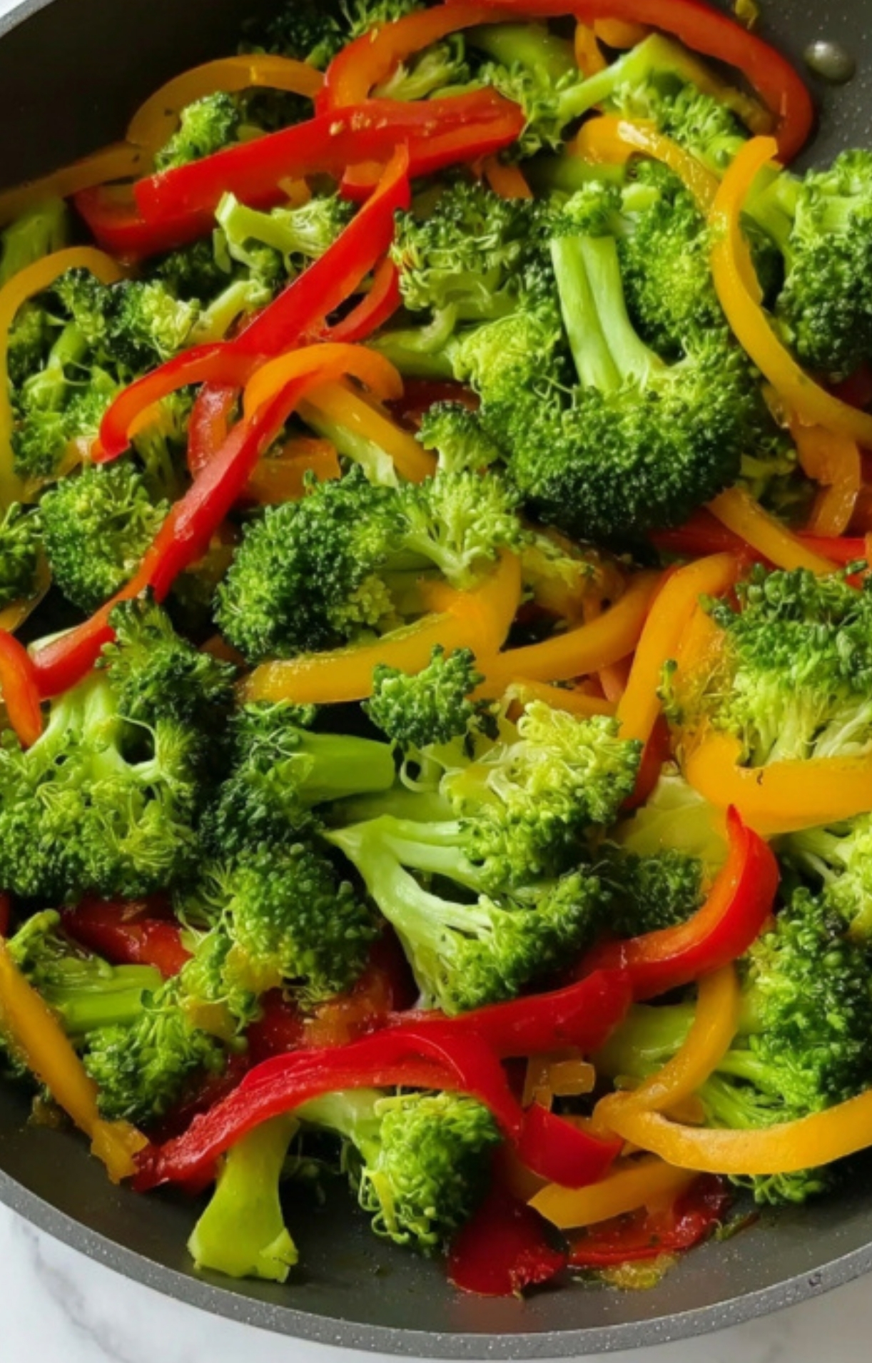 Bright green broccoli and sliced bell peppers in a skillet – easy vegetable stir fry for meal prep and weeknight dinners