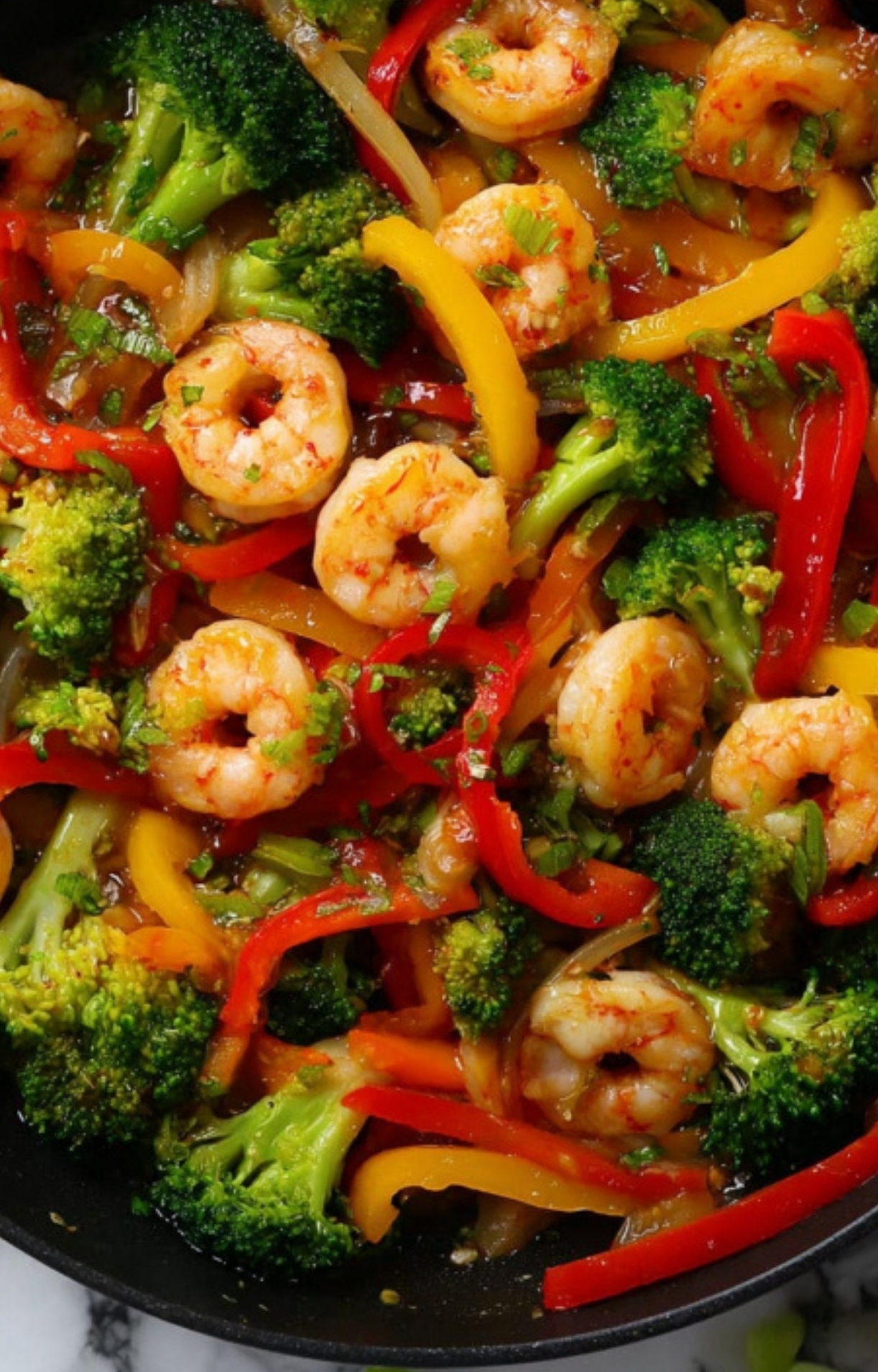 Colorful shrimp stir-fry with broccoli, red and yellow bell peppers in a skillet – easy healthy dinner ready in 15 minutes