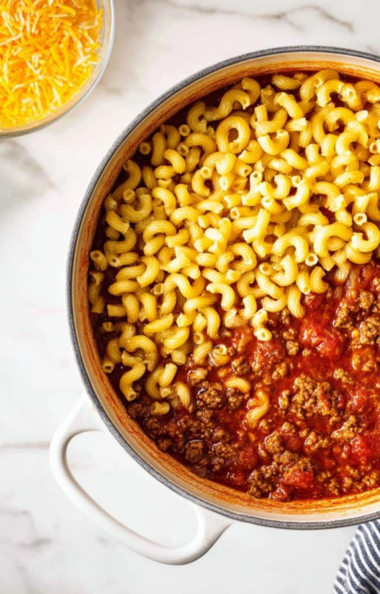 Pot of cooked macaroni and beefy tomato sauce ready to be mixed together. Fast and budget-friendly meal for busy families.