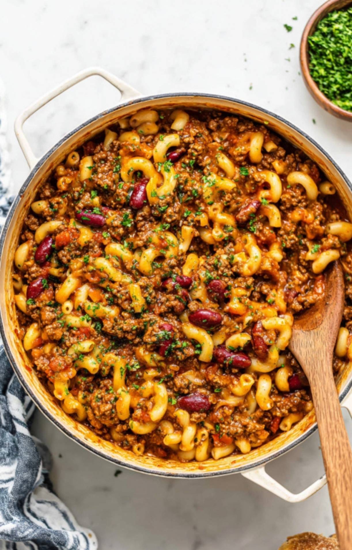 Large pot filled with cheesy goulash, kidney beans, and elbow noodles, ready to serve for a cozy, family-friendly dinner.