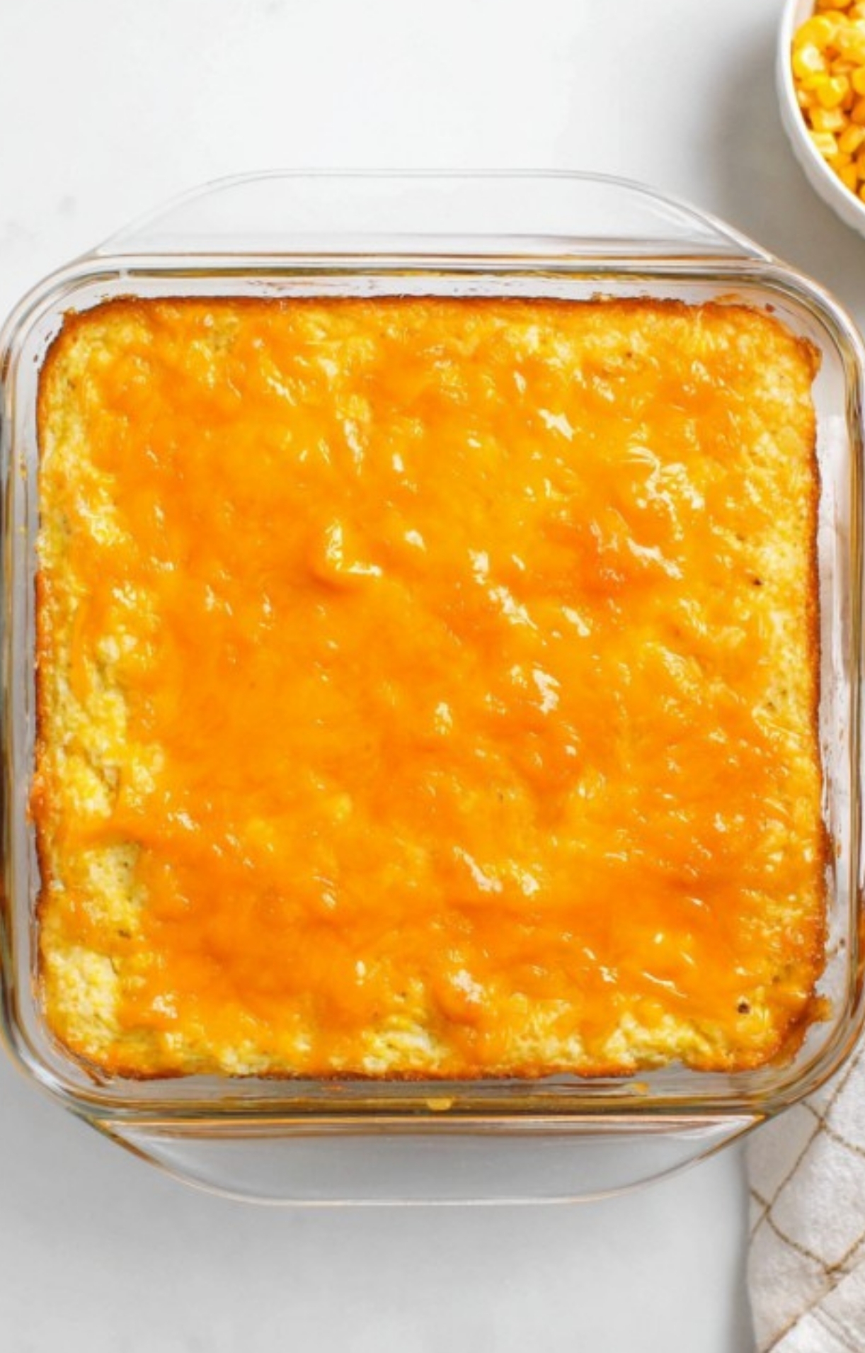 Freshly baked cream cheese corn casserole with a golden cheddar cheese topping, perfect for family dinners, potlucks, and festive holiday meals.