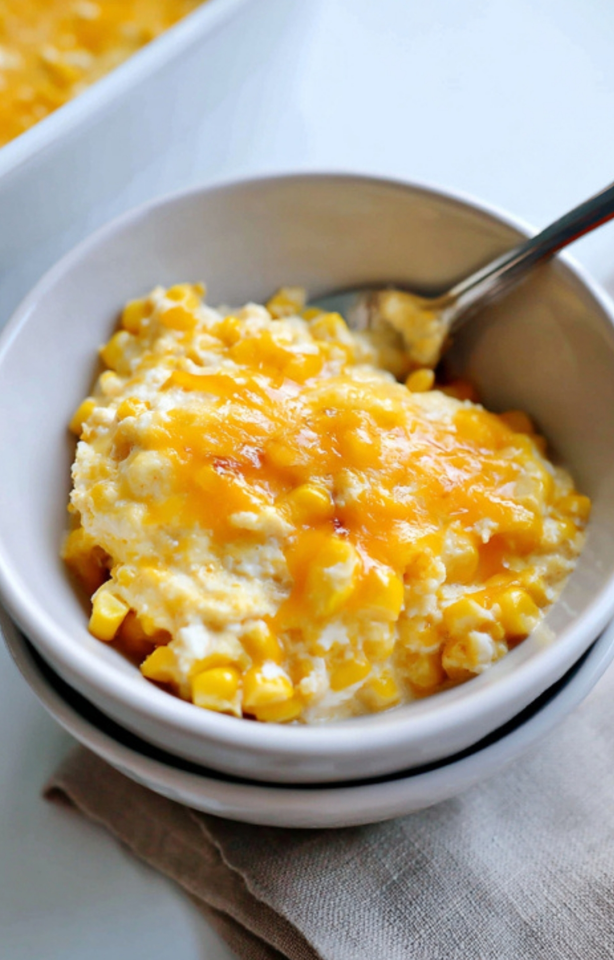 Bowl filled with creamy, cheesy corn casserole, showing a comforting side dish made with canned corn and cream cheese, ready to serve.