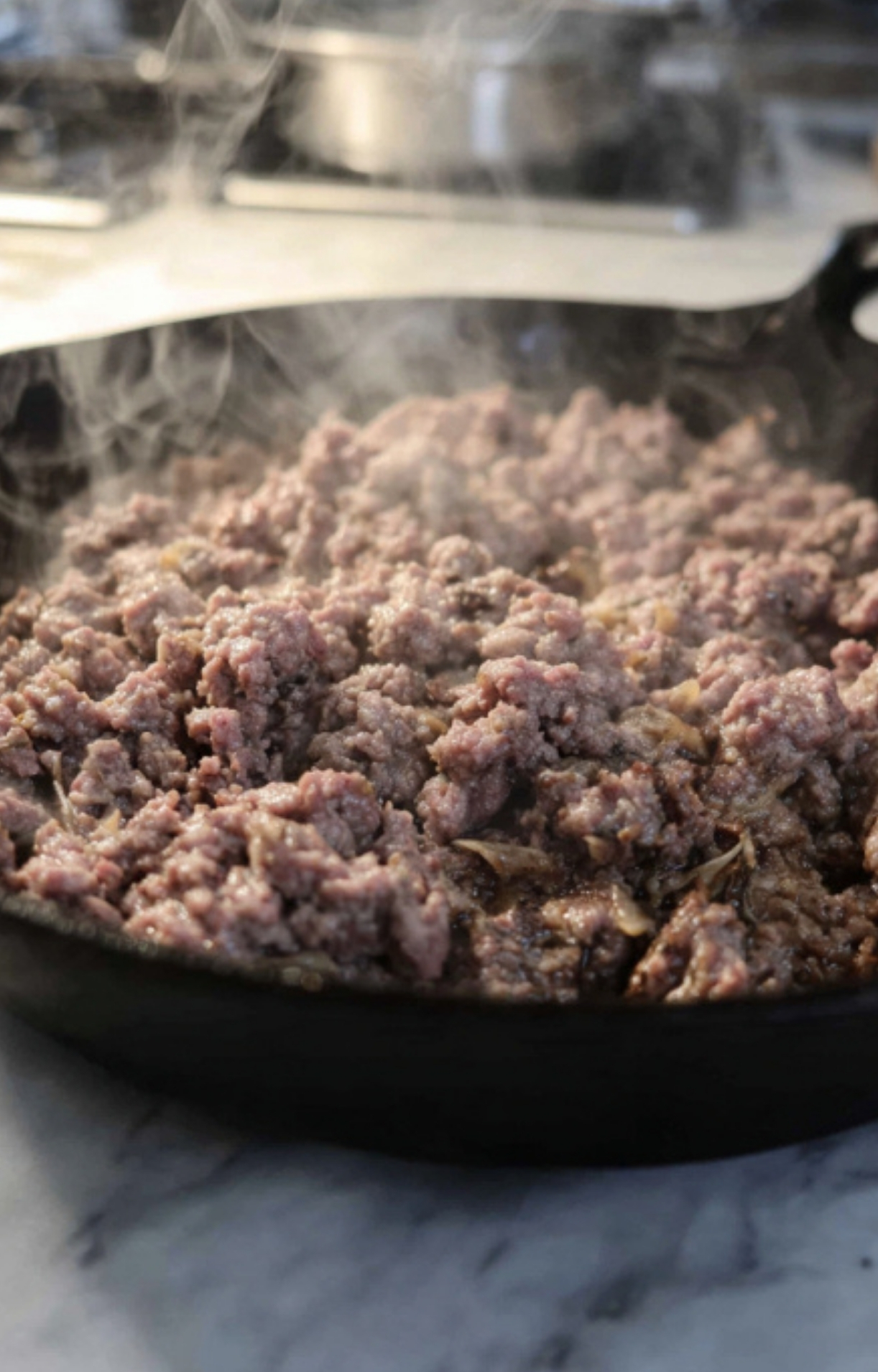 Ground beef cooking in a skillet for Salisbury Steak Casserole. This is the first step to building rich, savory flavor for an easy skillet dinner.
