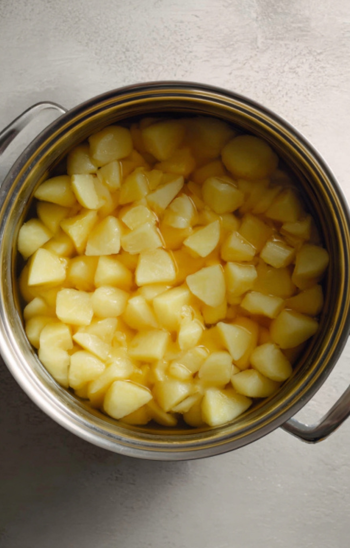 Pot of cubed Yukon gold potatoes boiling in water, the first step for crispy cheesy bacon ranch potatoes.
