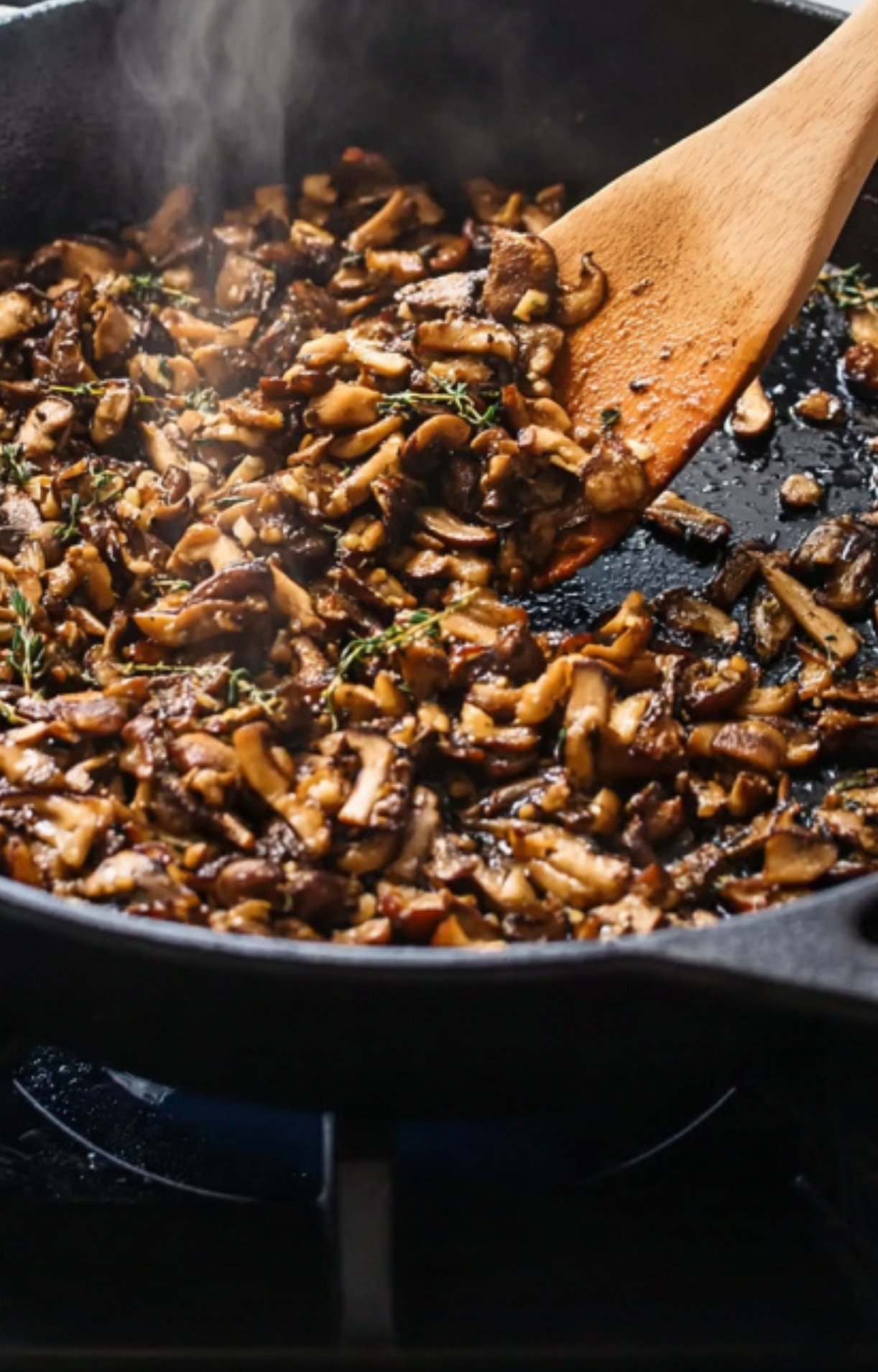 Finely chopped mushrooms cooking in a skillet for making mushroom duxelles, essential for classic sous vide beef wellington.