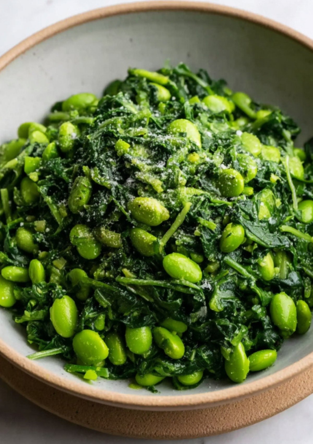 Bright green spinach and edamame mixture in a bowl, ready for stuffing beef wellington, adding color and nutrition to the dish.