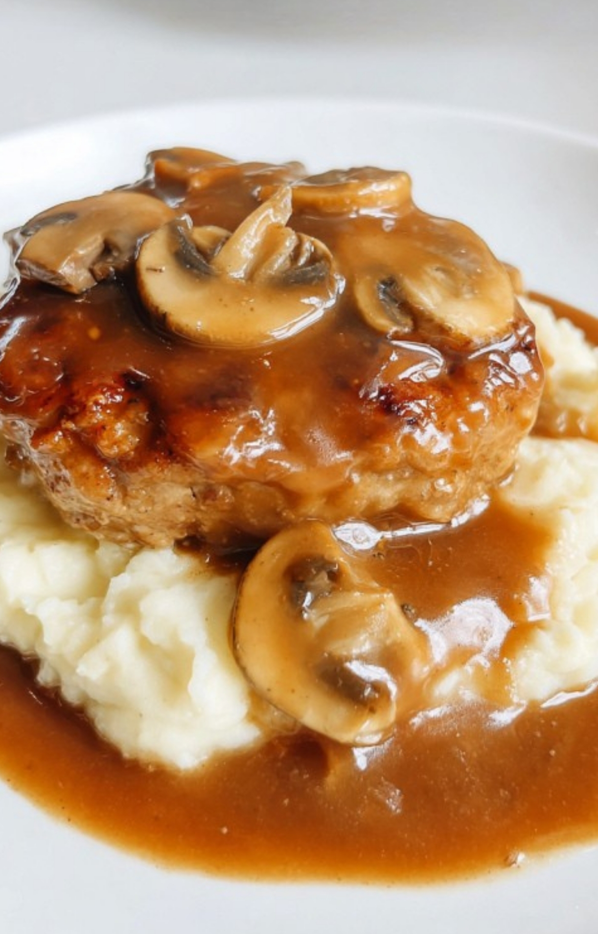 Juicy ground turkey Salisbury steak topped with mushroom gravy served over creamy mashed potatoes.