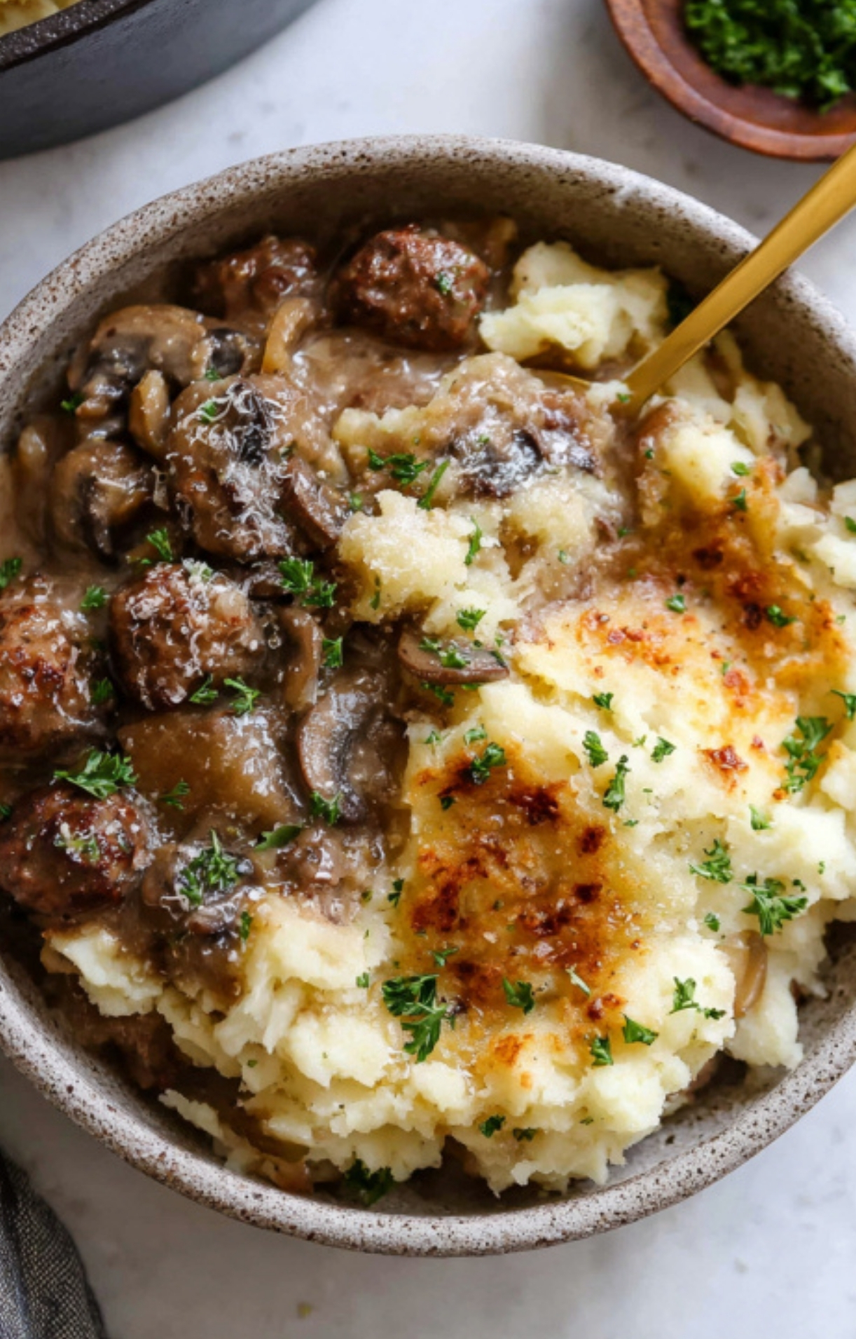 Creamy mashed potatoes spread over the beef and gravy mixture, ready for baking. The perfect topping for this easy weeknight casserole.
