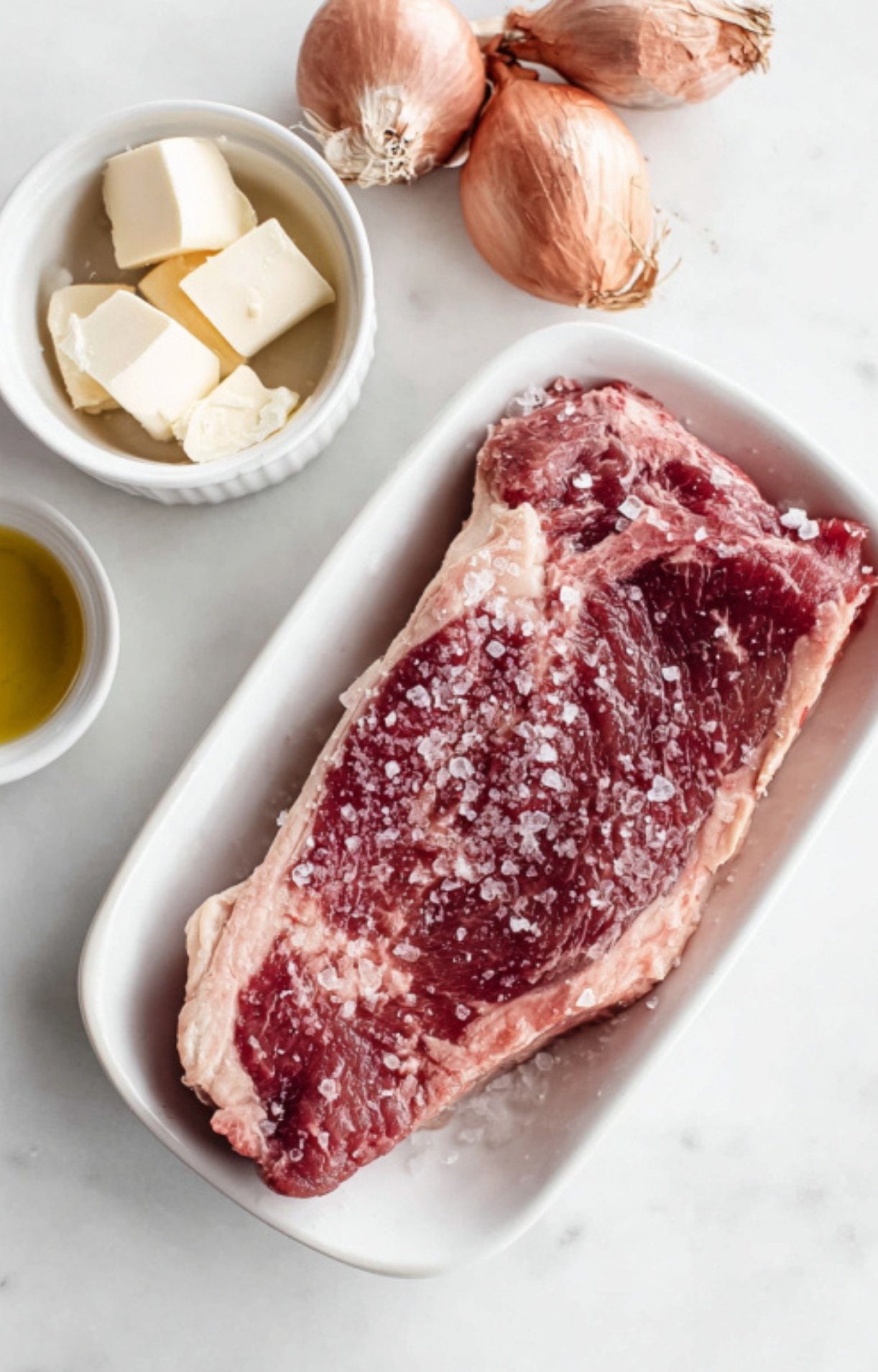 New York strip steak sprinkled with coarse salt, butter, and shallots for a fast skillet dinner.