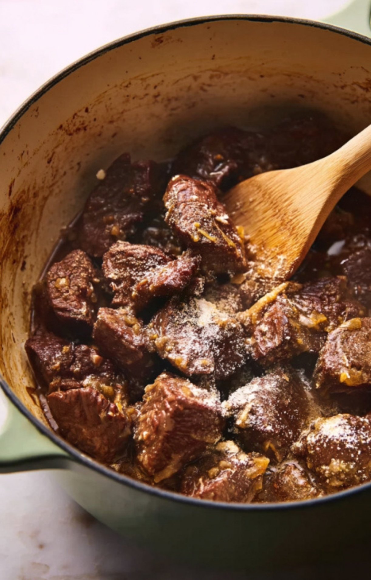 Beef cubes browning in a Dutch oven to build depth of flavor in a classic French beef stew. Perfect for cozy winter recipes.