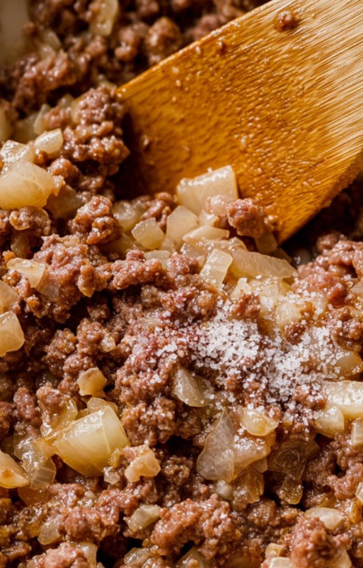 Ground beef and onions sizzling in a skillet, ready for a classic one-pot American goulash. Simple steps for cozy homemade dinner.