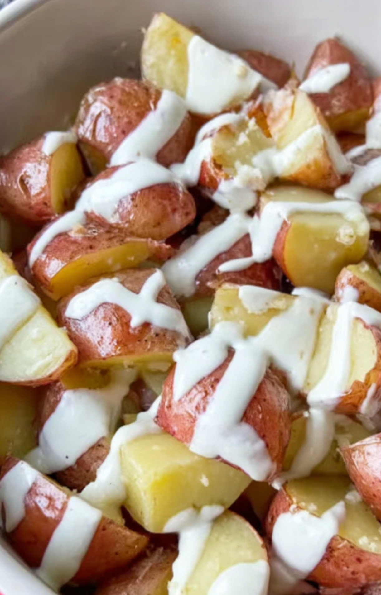 Boiled potatoes generously coated in creamy ranch dressing, the perfect prep for cheesy baked potatoes.
