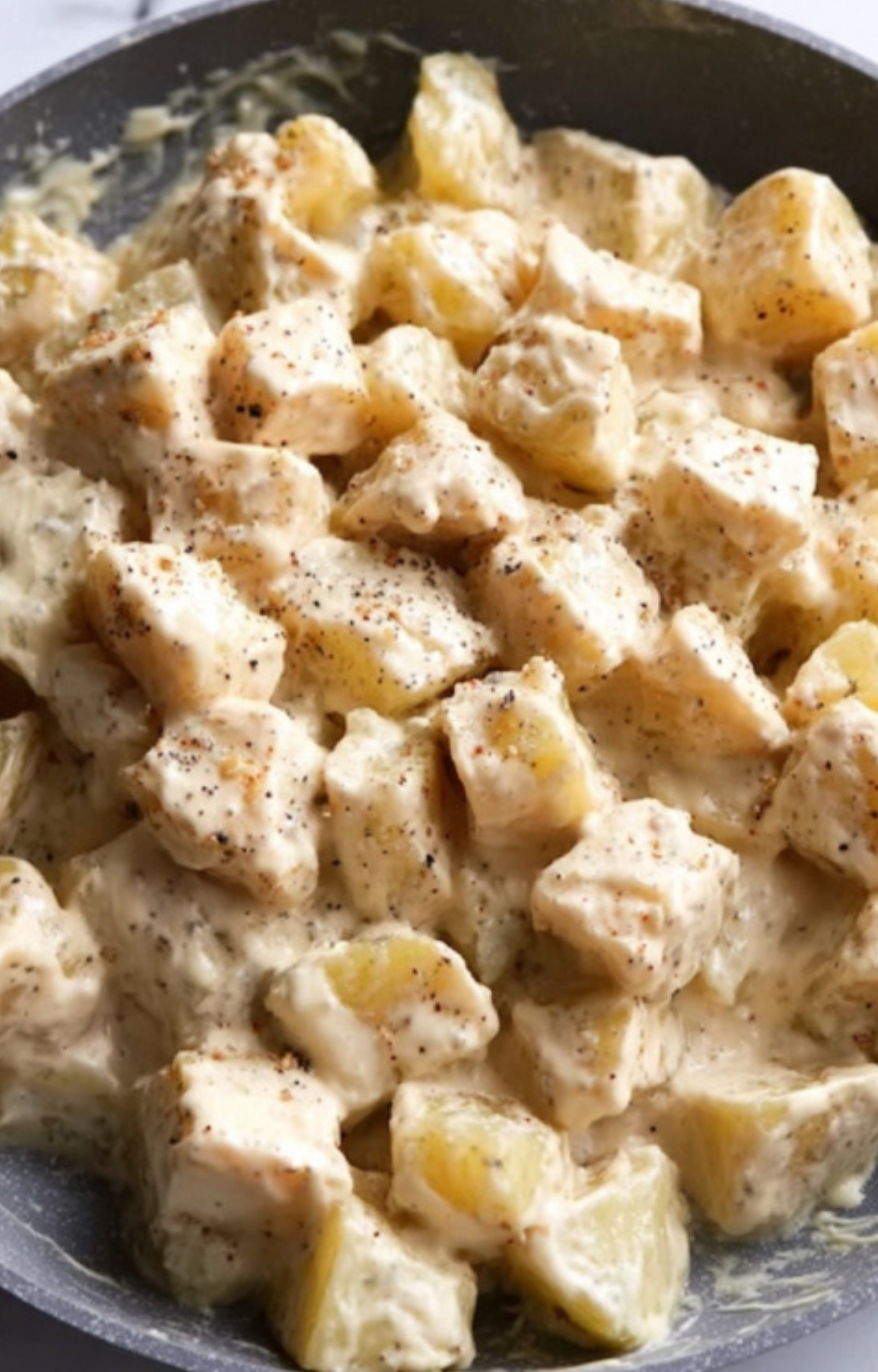 Cubed potatoes in a bowl, ideal for roasting. Great for making loaded potato bakes or cheesy sides.