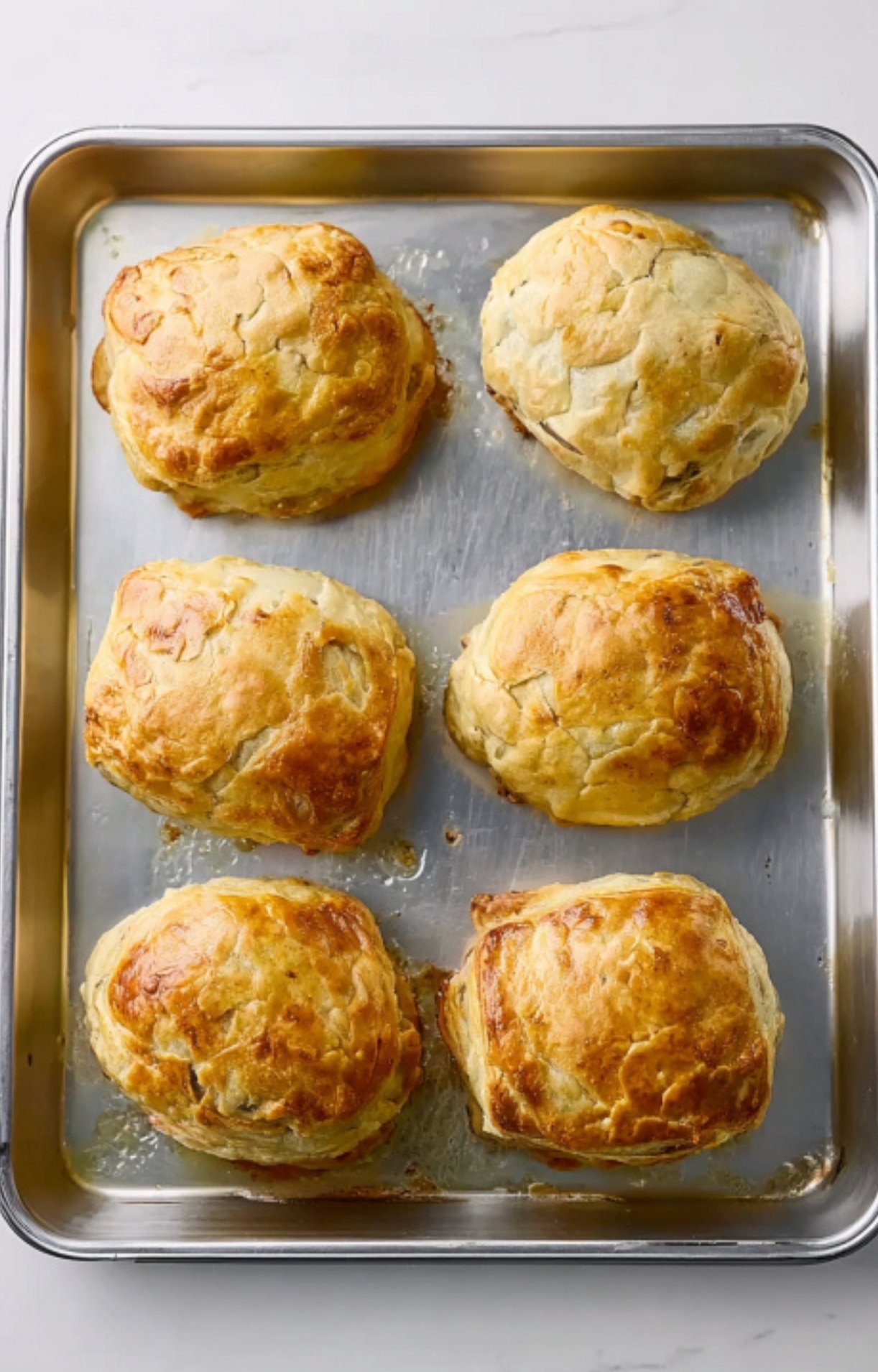 Tray of six individual beef wellingtons baked to golden perfection. Great for party appetizers, family dinners, or hosting a special occasion with elegant beef recipes.