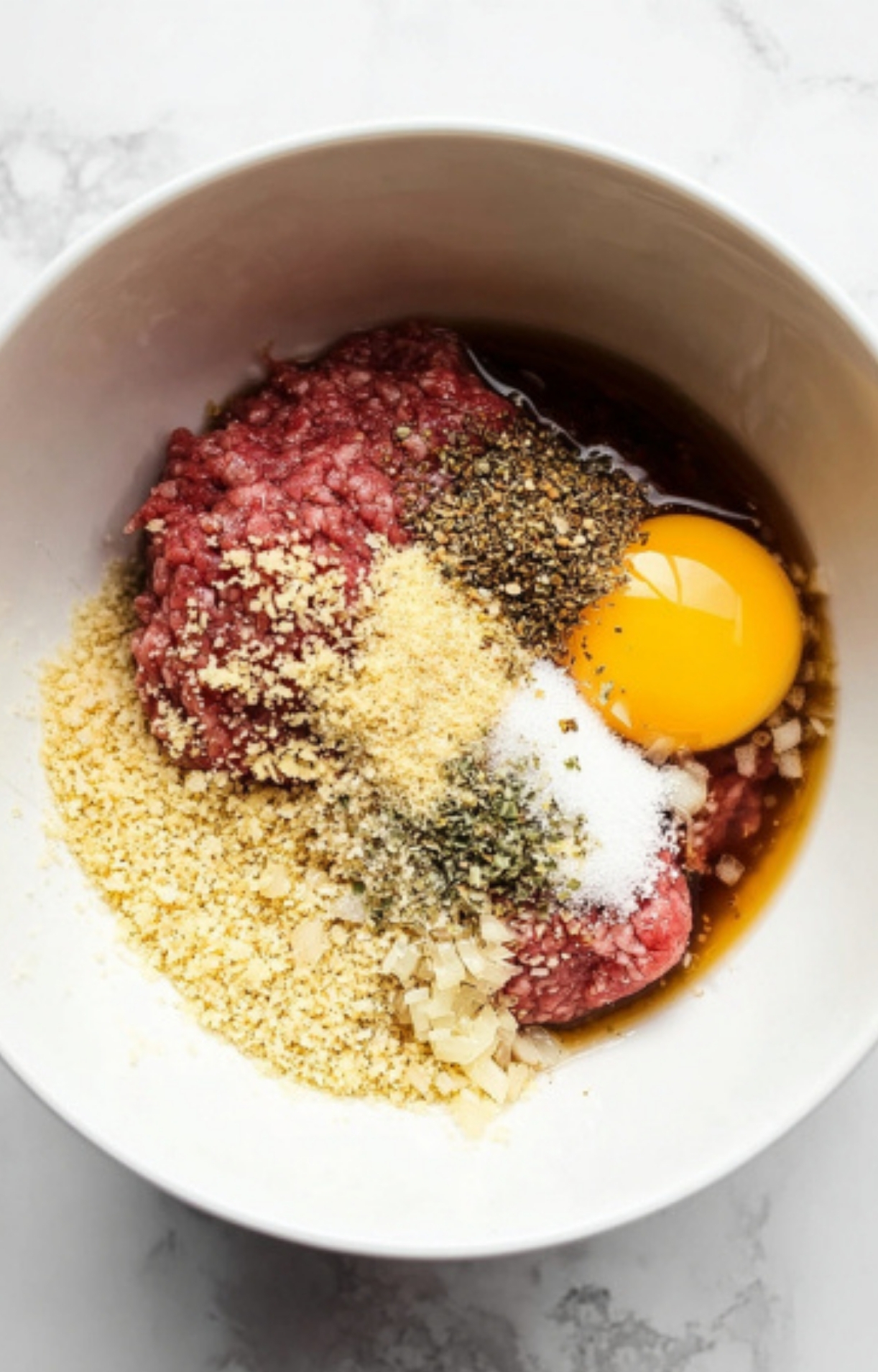 Ground beef, egg, breadcrumbs, and savory spices mixed in a bowl for juicy Salsberry Steak With Mushroom Gravy—classic comfort food for busy weeknights, family meals, and budget-friendly dinners.