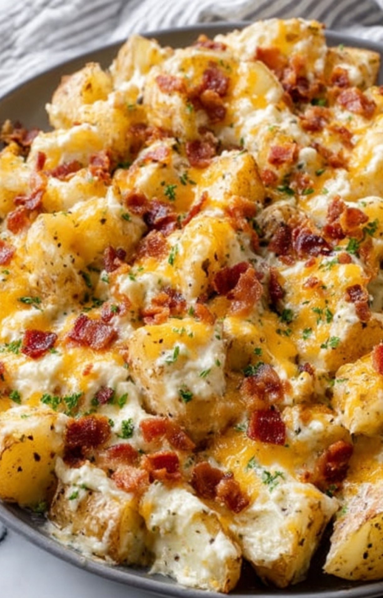 Potatoes coated in creamy ranch sauce, ready for the oven. The perfect base for cheesy baked potato casserole.